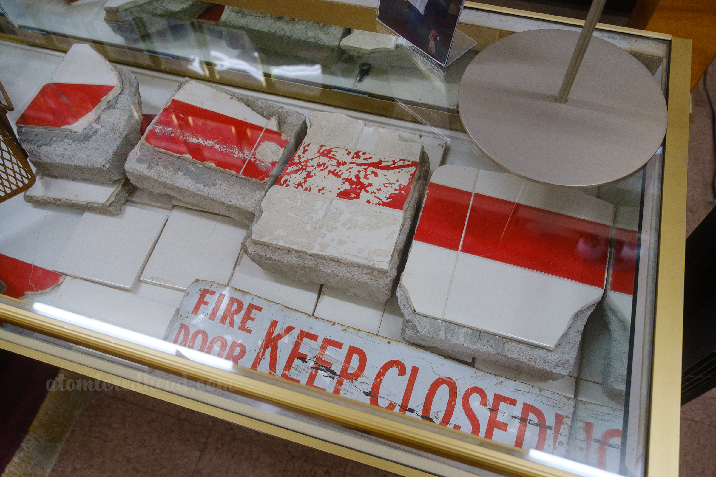 Broken pieces of tile, and a "Fire Door KEEP CLOSED" sign remains from Kroc's "revenge" location.