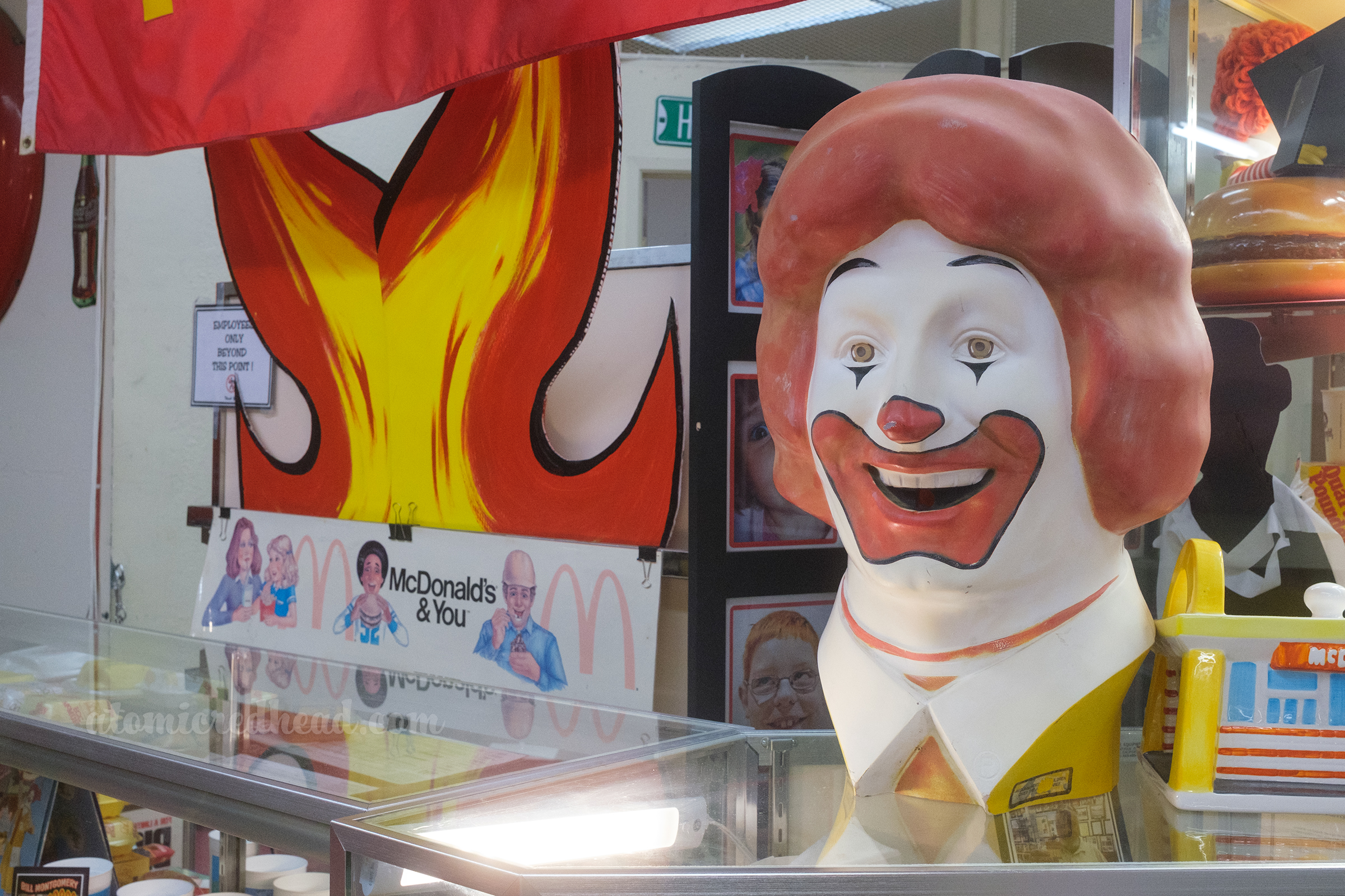 A large Ronald McDonald head sits on a display case.