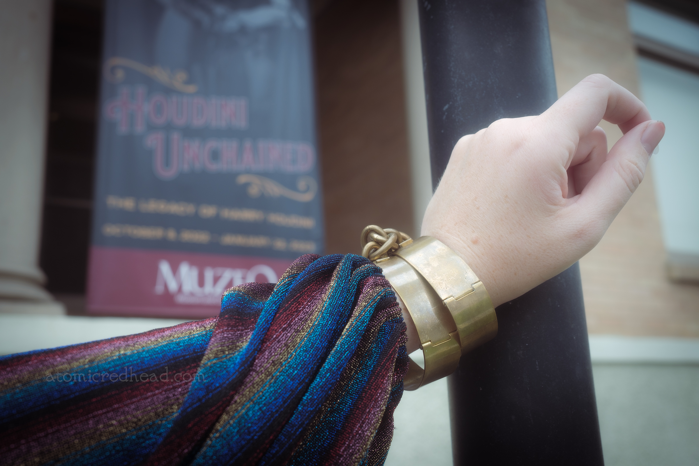 Close-up of my gold, handcuff like bracelets.