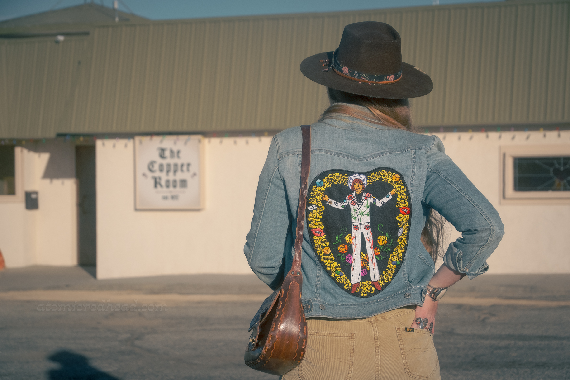 Myself from the back, showing off a large patch featuring Gram Parsons in his white Nudie suit, surrounded by yellow flowers and pills.