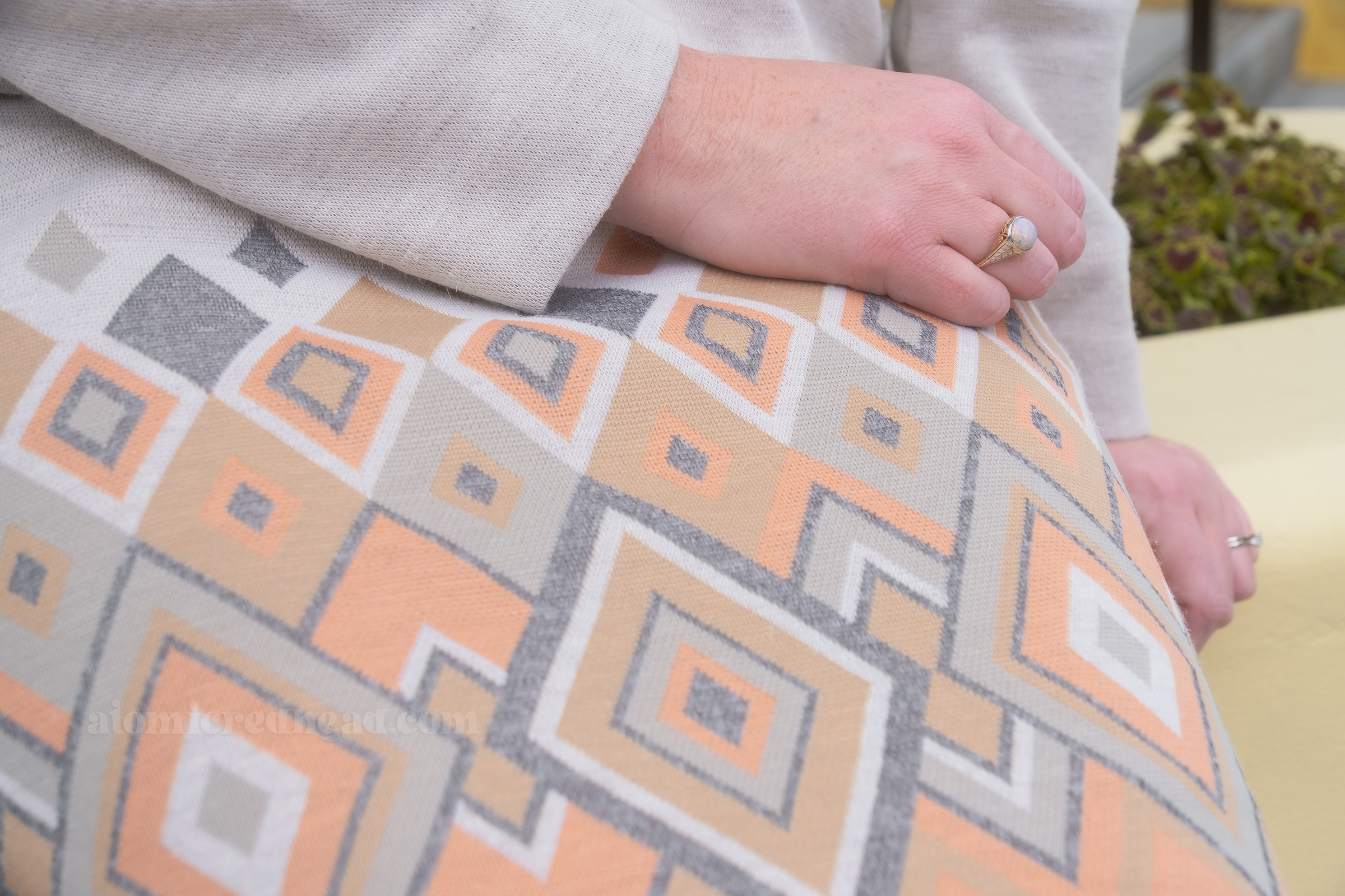 Close-up of the diamond pattern, of shades of grey, gold, pink, and taupe.