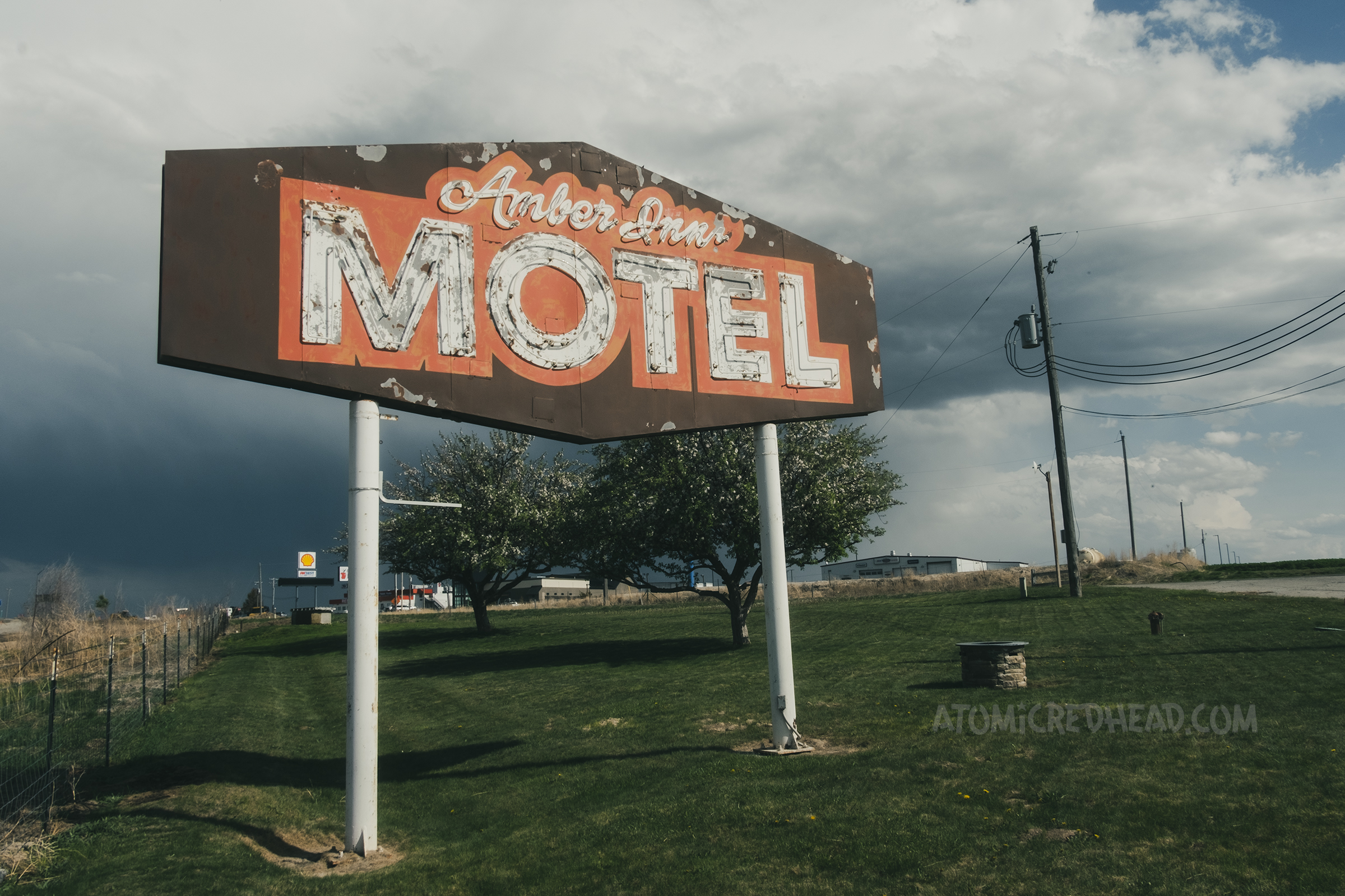 A large faded sign reads "Amber Inn Motel" in neon.