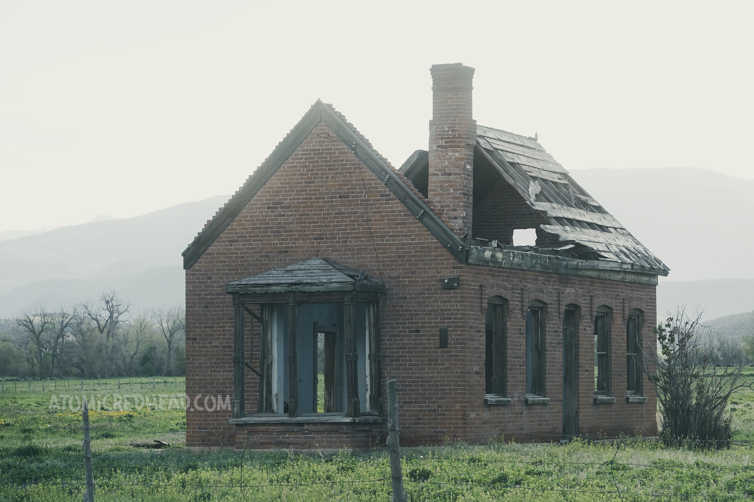 A partially burned down home made of brick.