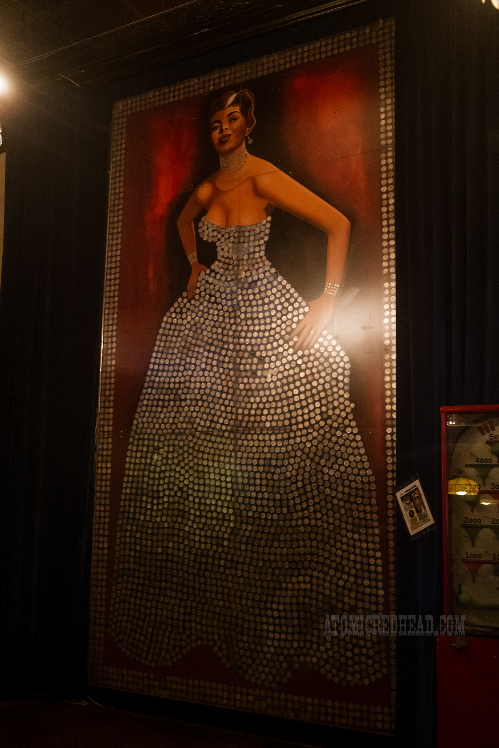 View of the Silver Queen herself, a 16 foot tall portrait of a woman in a dress made up of silver dollars.