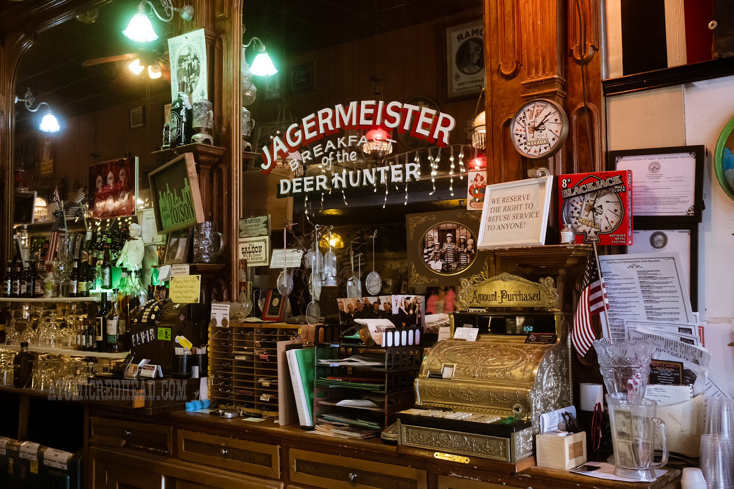 View of the bar back with mirrors and steer horns hanging above.