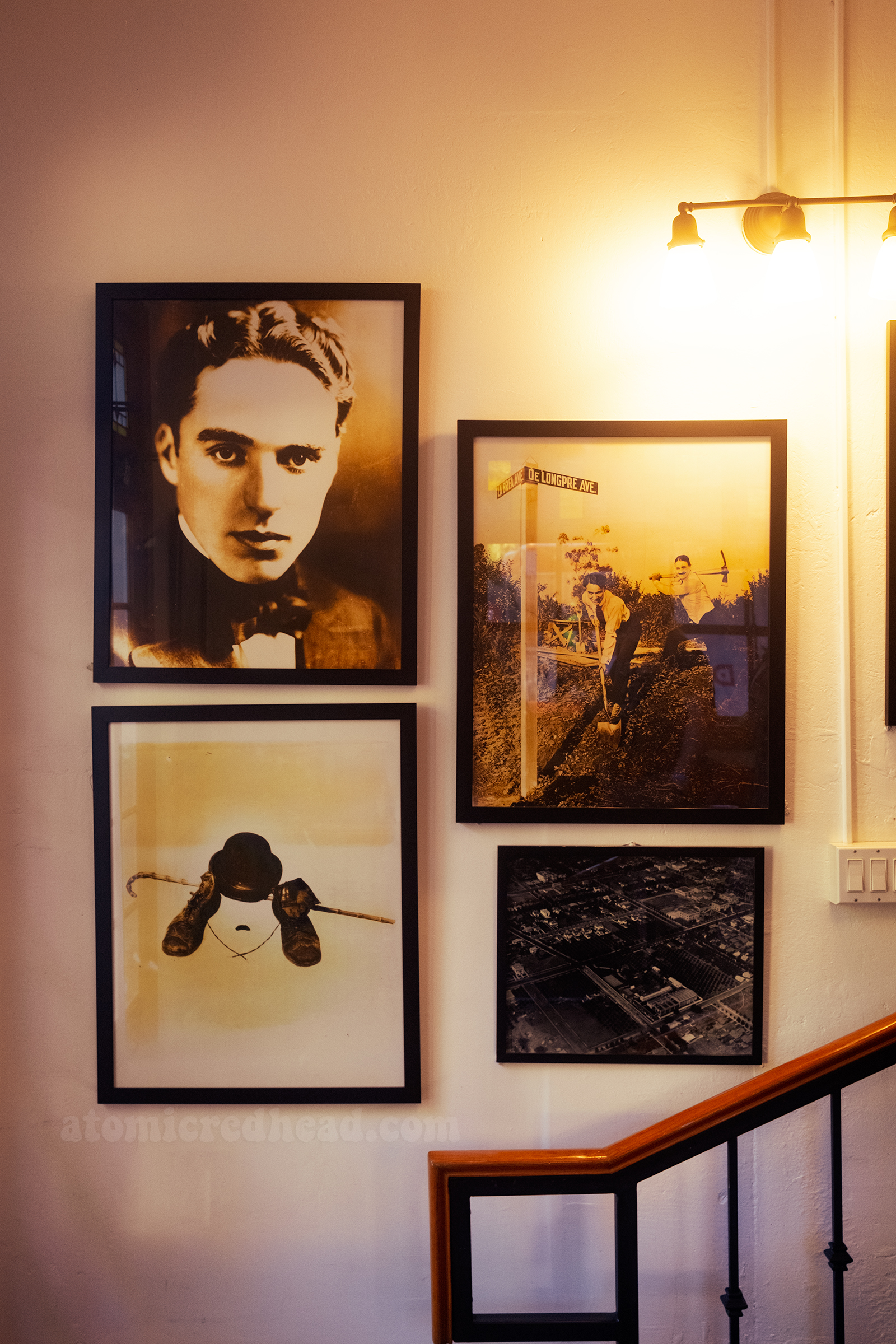 Various framed photographs of Charlie Chaplin on the wall.