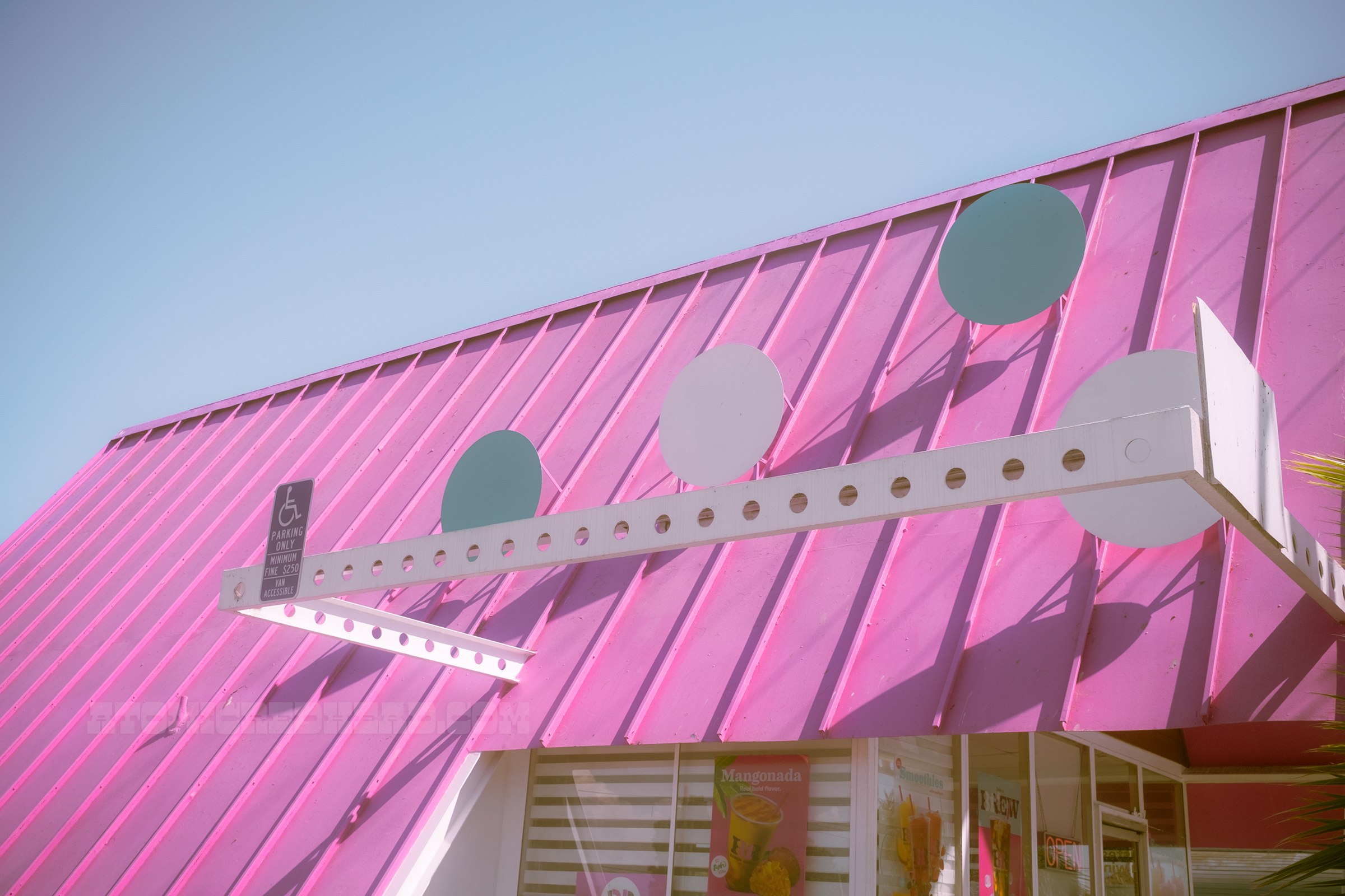 Close-up of the dots on the roof which are raised from the roof, across the front is a white beam with circles cut out.
