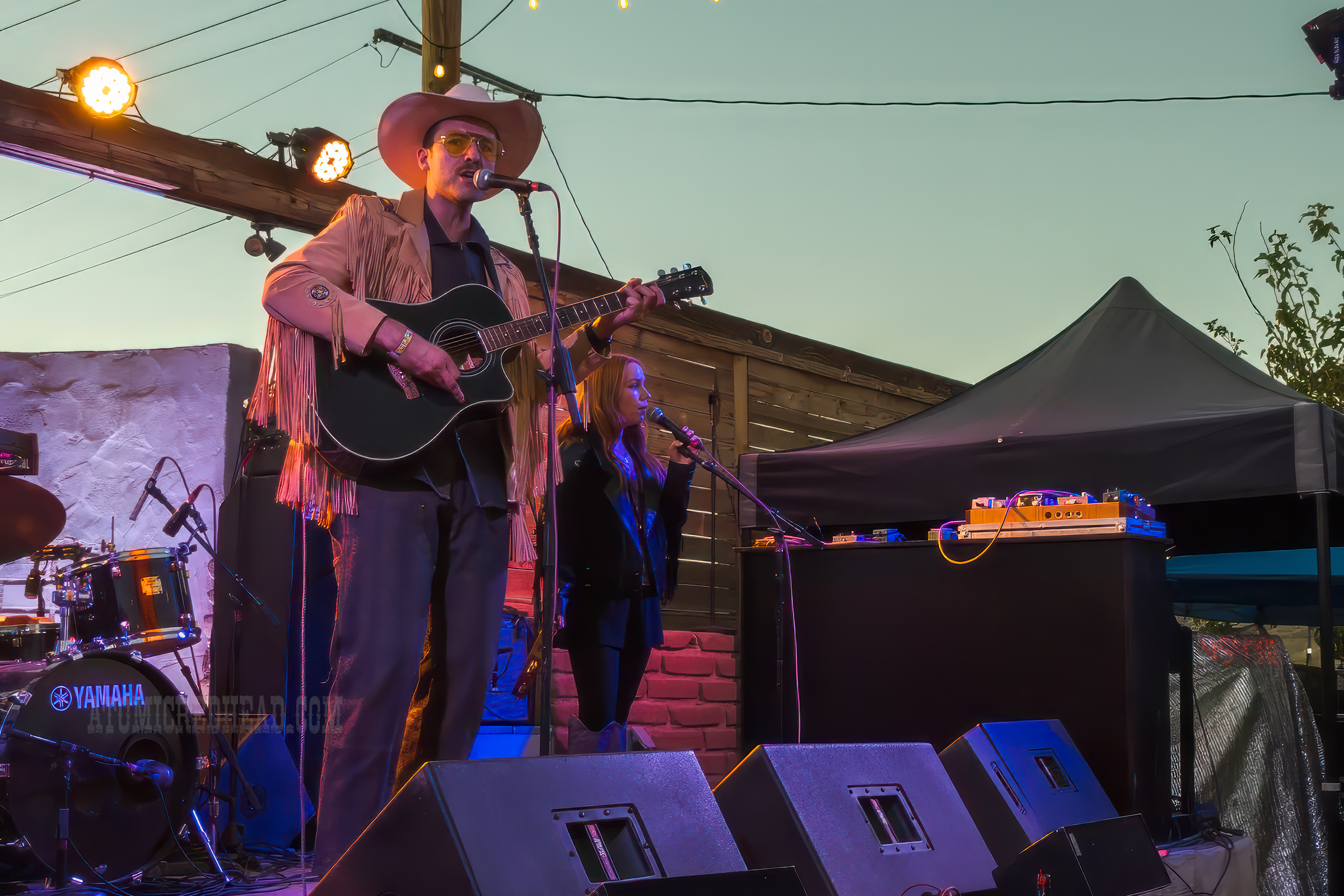 Dale Hollow plays the guitar on stage.