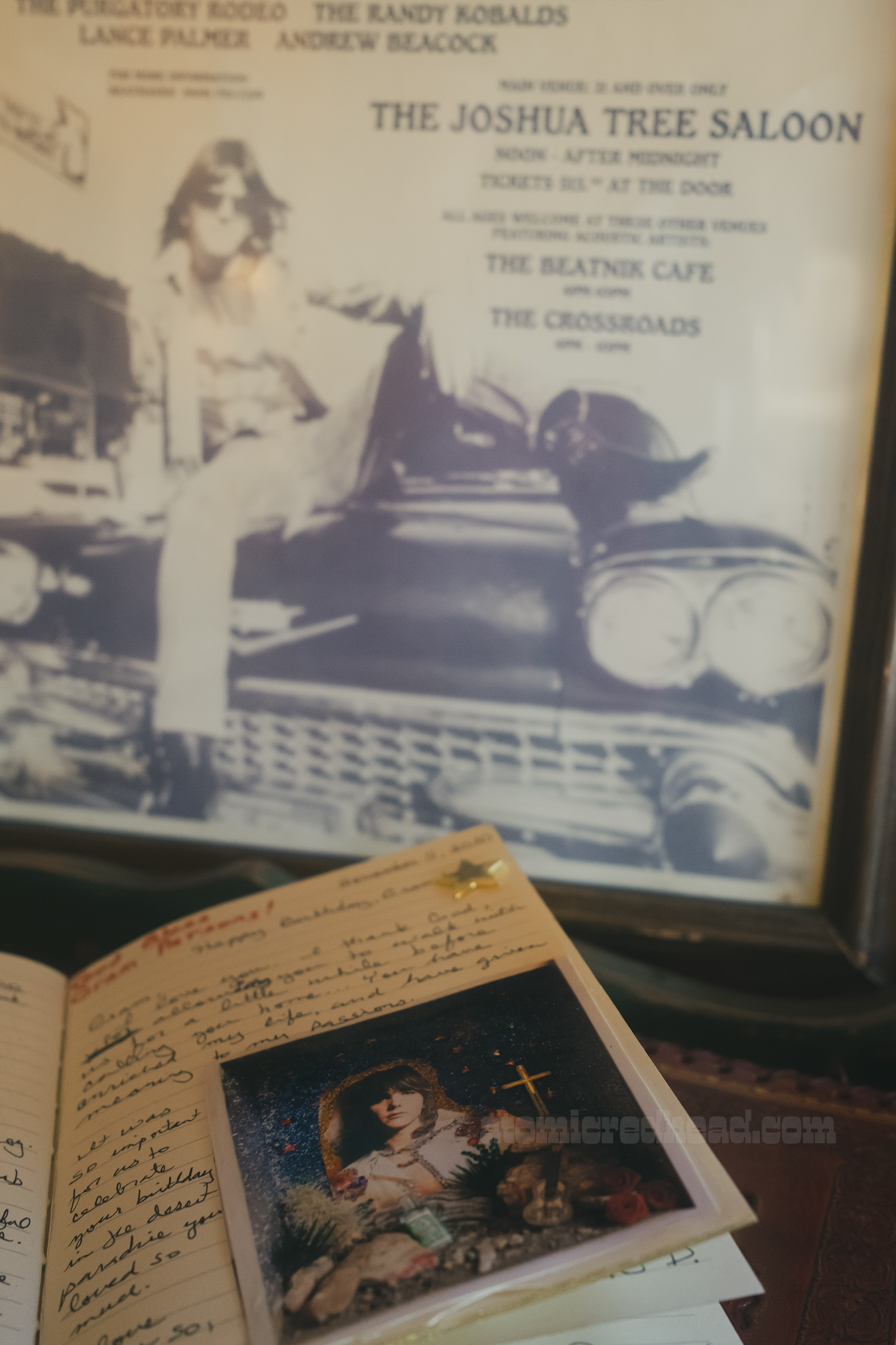 Close-up of a book where people share their memories of Gram, behind it is a poster of Gram.