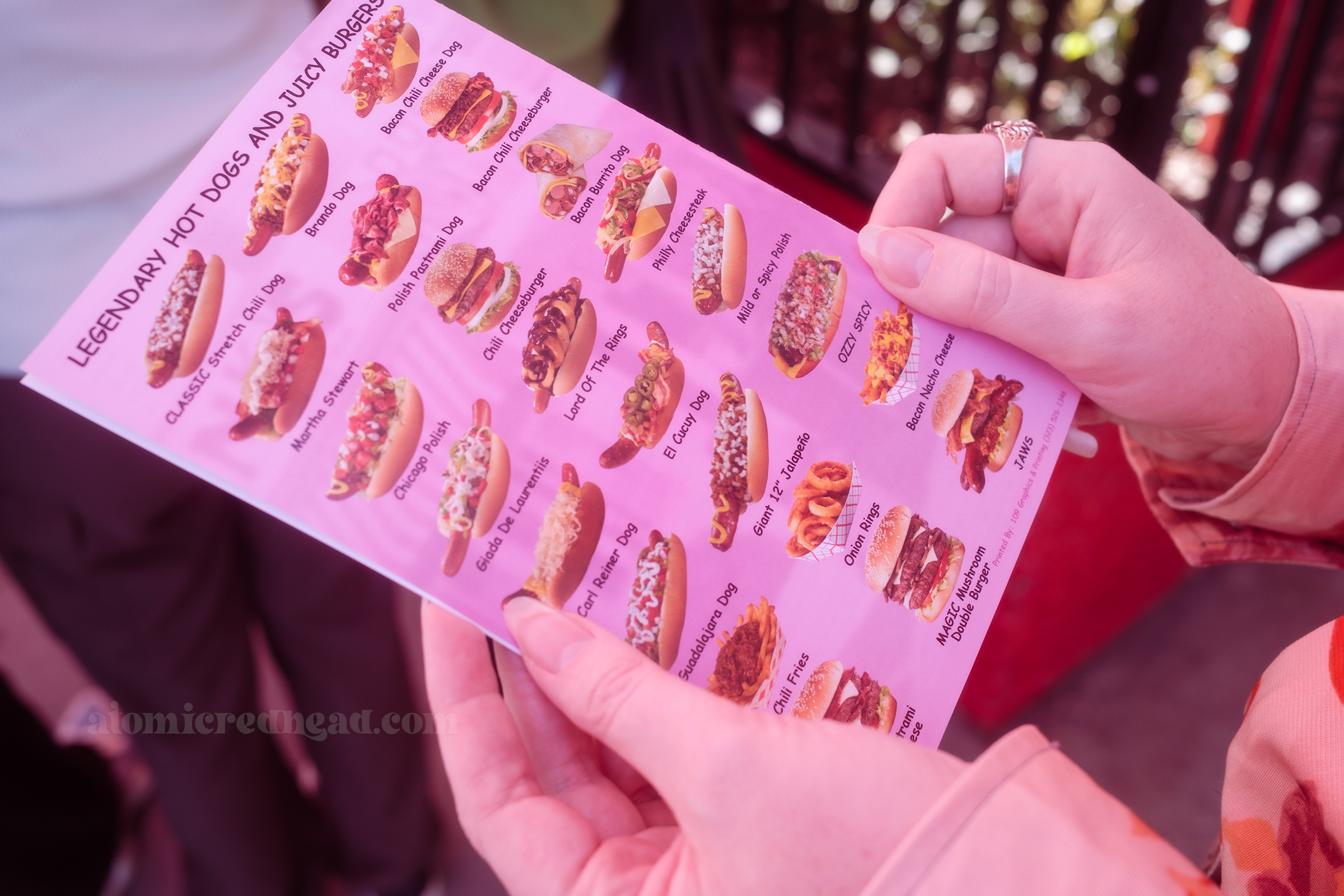 A look at the menu, featuring images of various hot dogs and burgers, with names such as "Brando Dog, Bacon Burrito Dog," and "Carl Reiner Dog"