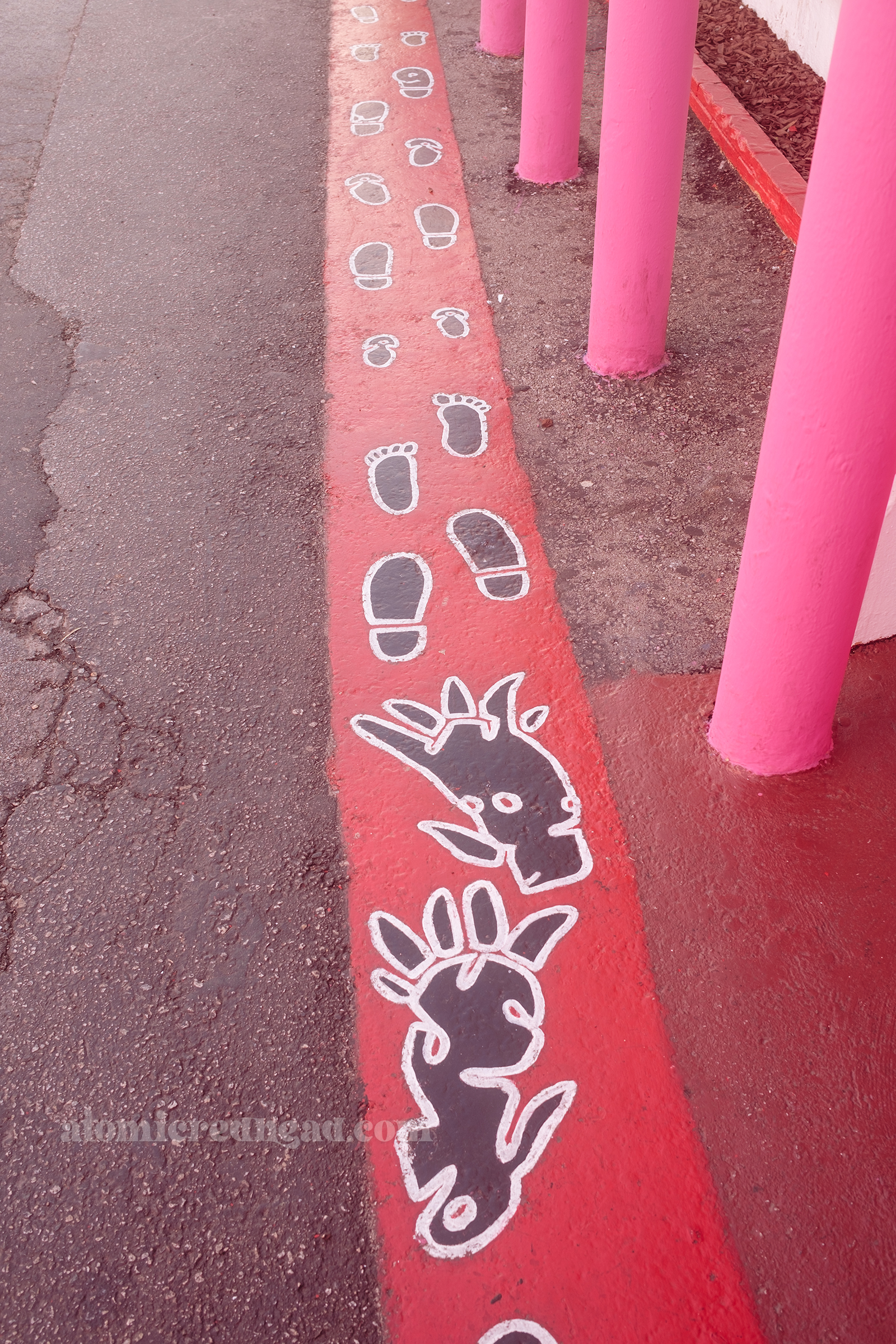 Painted foot prints of bare feet, monsters, and shoes, guide hunger visitors in line.