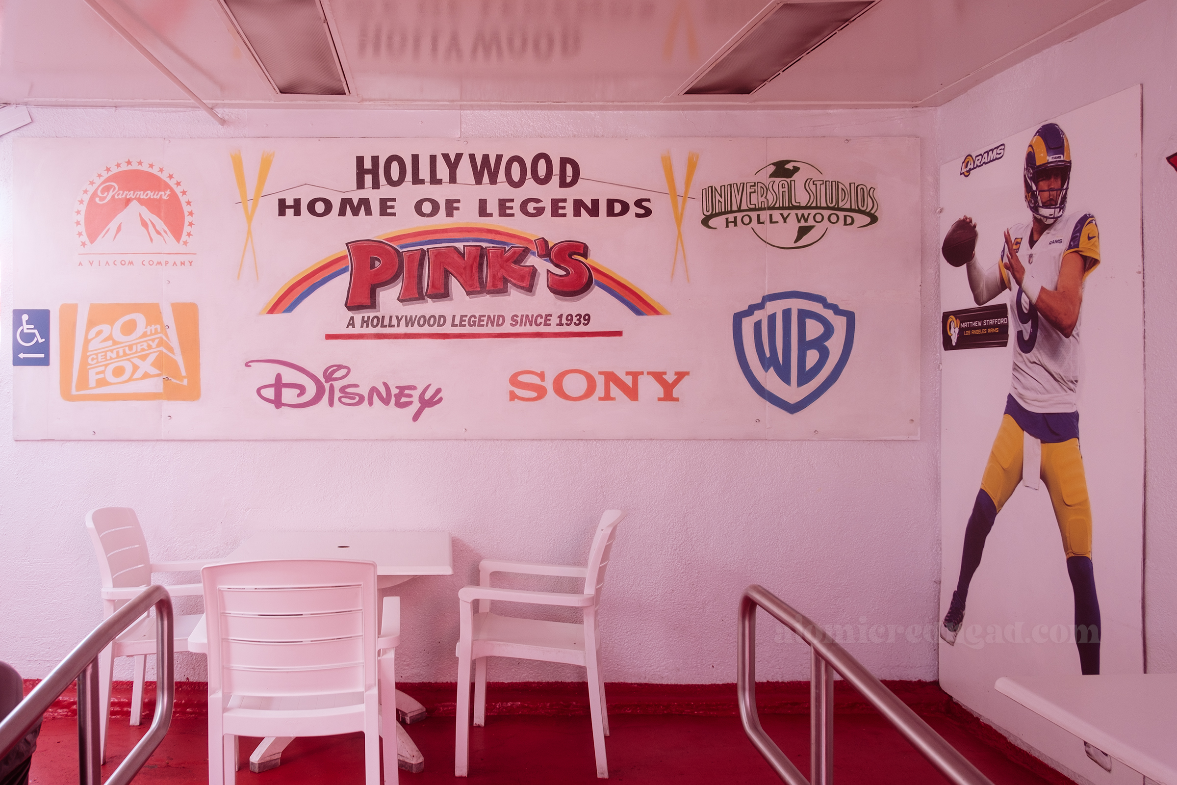 A mural reads "Hollywood Home of Legends Pink's A Hollywood Legend since 1939" and features the logo designs for Paramount, 20th Century Fox, Disney, Sony, Universal Studios, and Warner Bros.