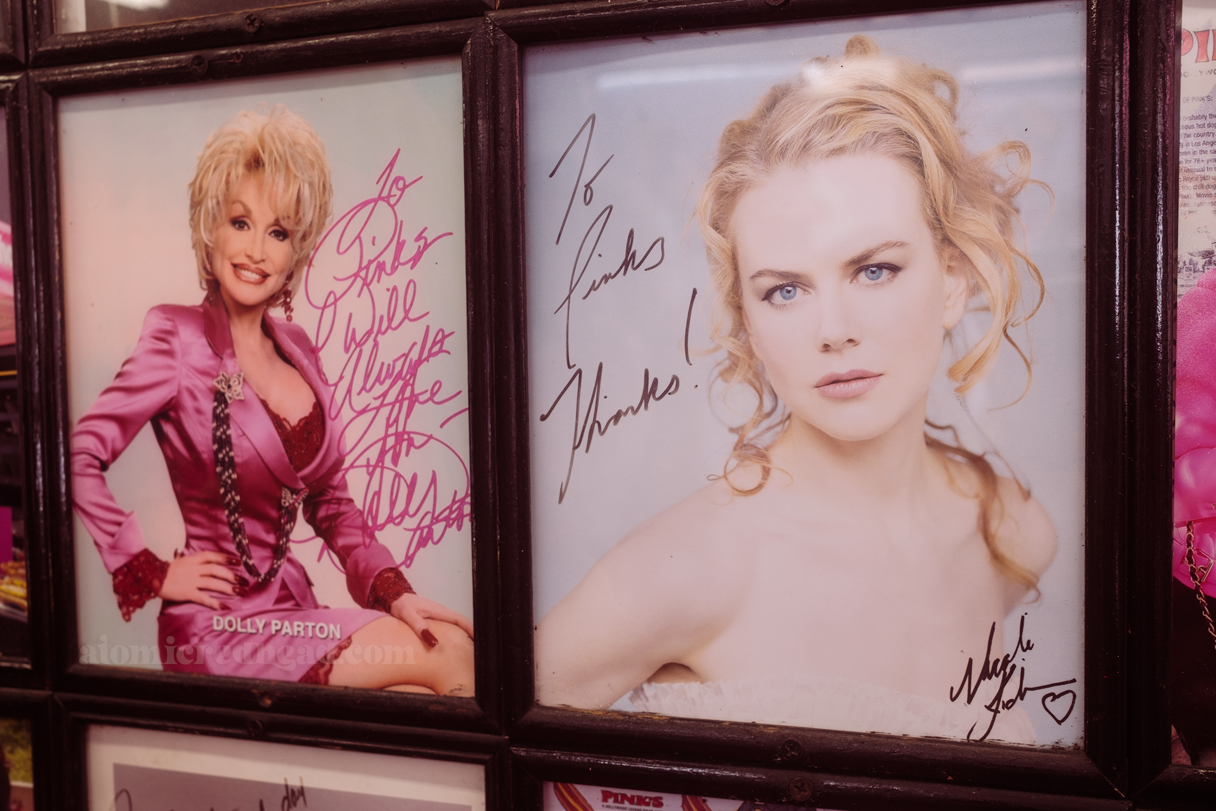 Autographed photos of Dolly Parton and Nicole Kidman. Dolly wears a pink outfit and it reads "To Pink's I will always love you Dolly Parton" and Kidman's reads "To Pink's Thanks Nicole Kidman"