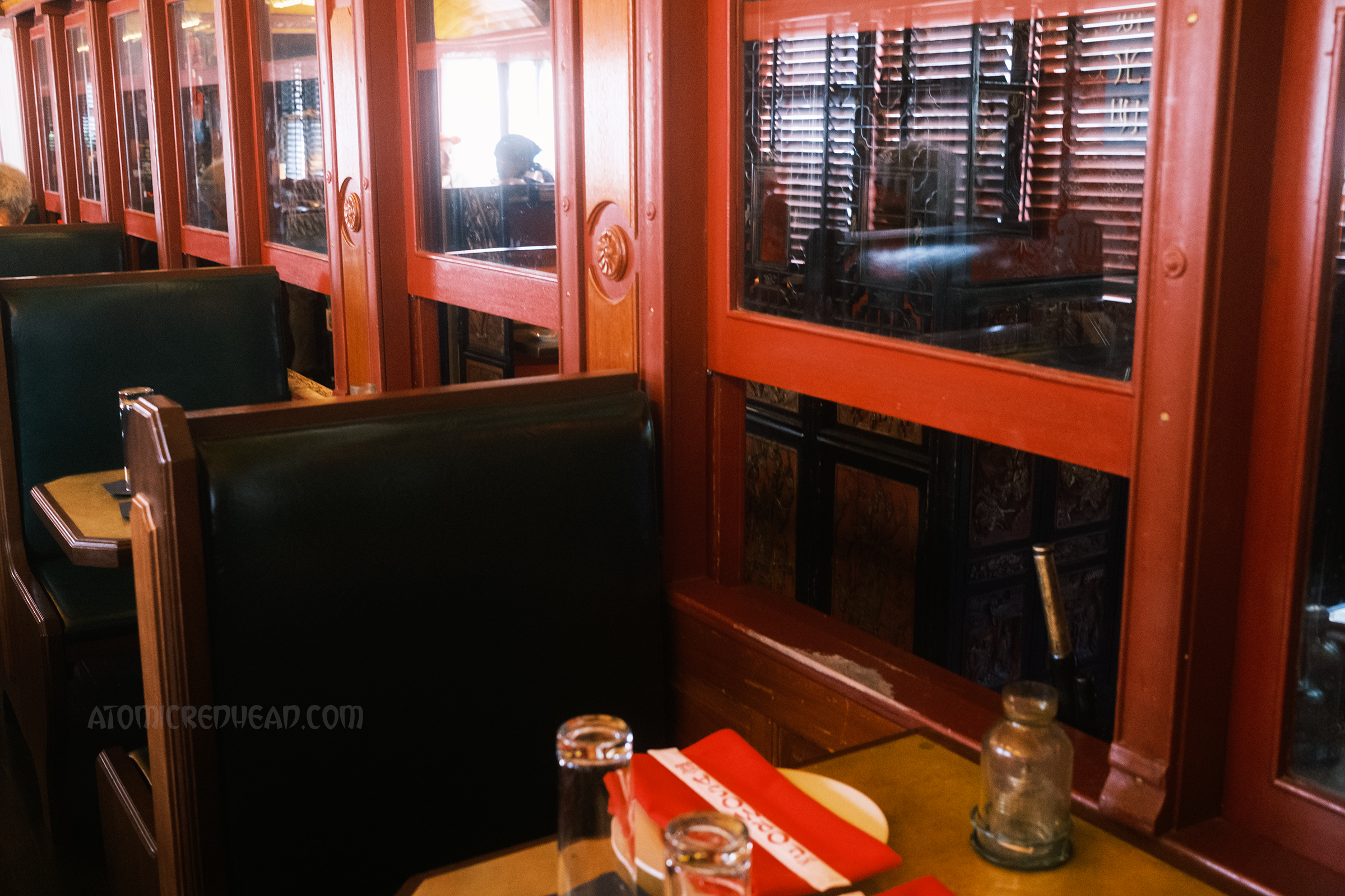 Small booths sit inside the train car.