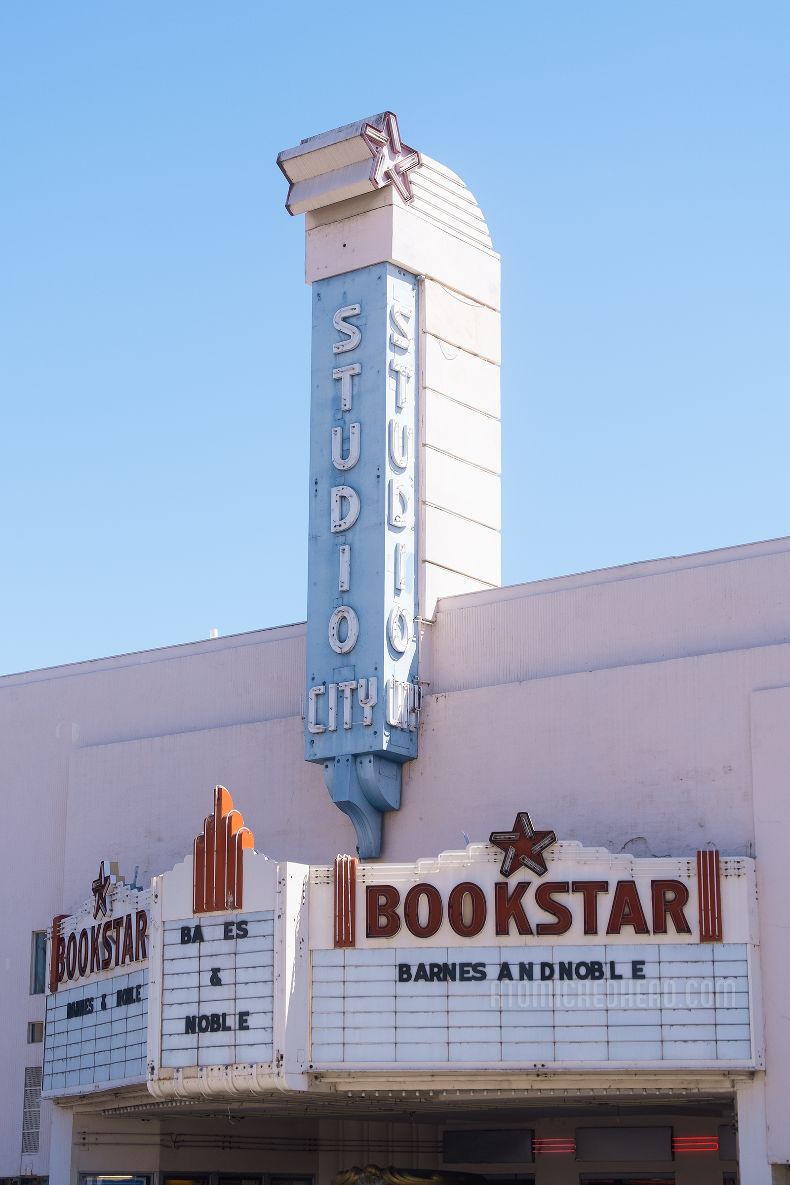 Exterior of the top portion, which features a tower of neon reading "Studio City" below the marquee reads "Bookstar" in neon and "Barnes and Noble" on the marquee.