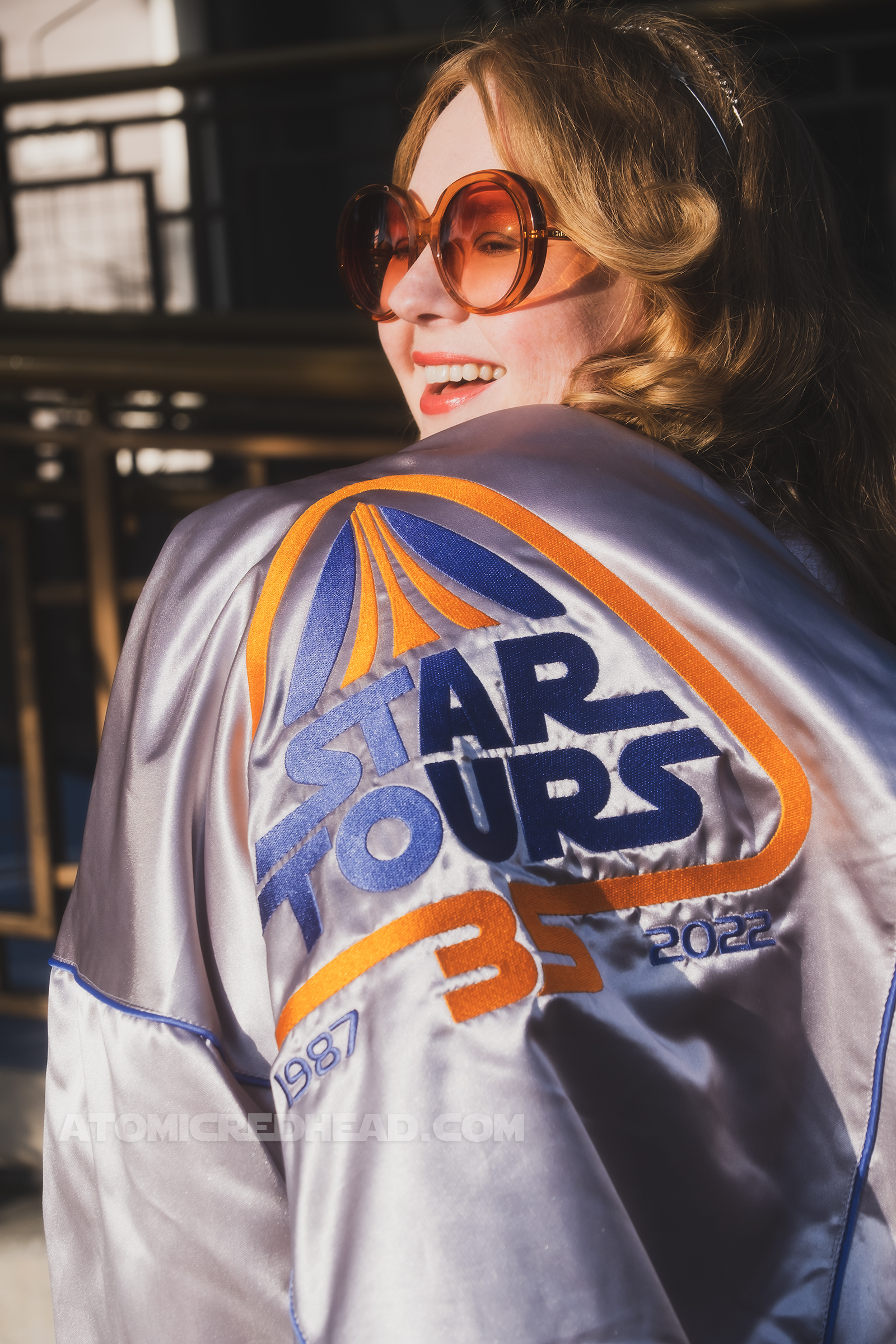 Close-up of the back of my jacket, hanging over my shoulder. In blue and orange embroidery it reads "Star Tours 35 1987 2022"