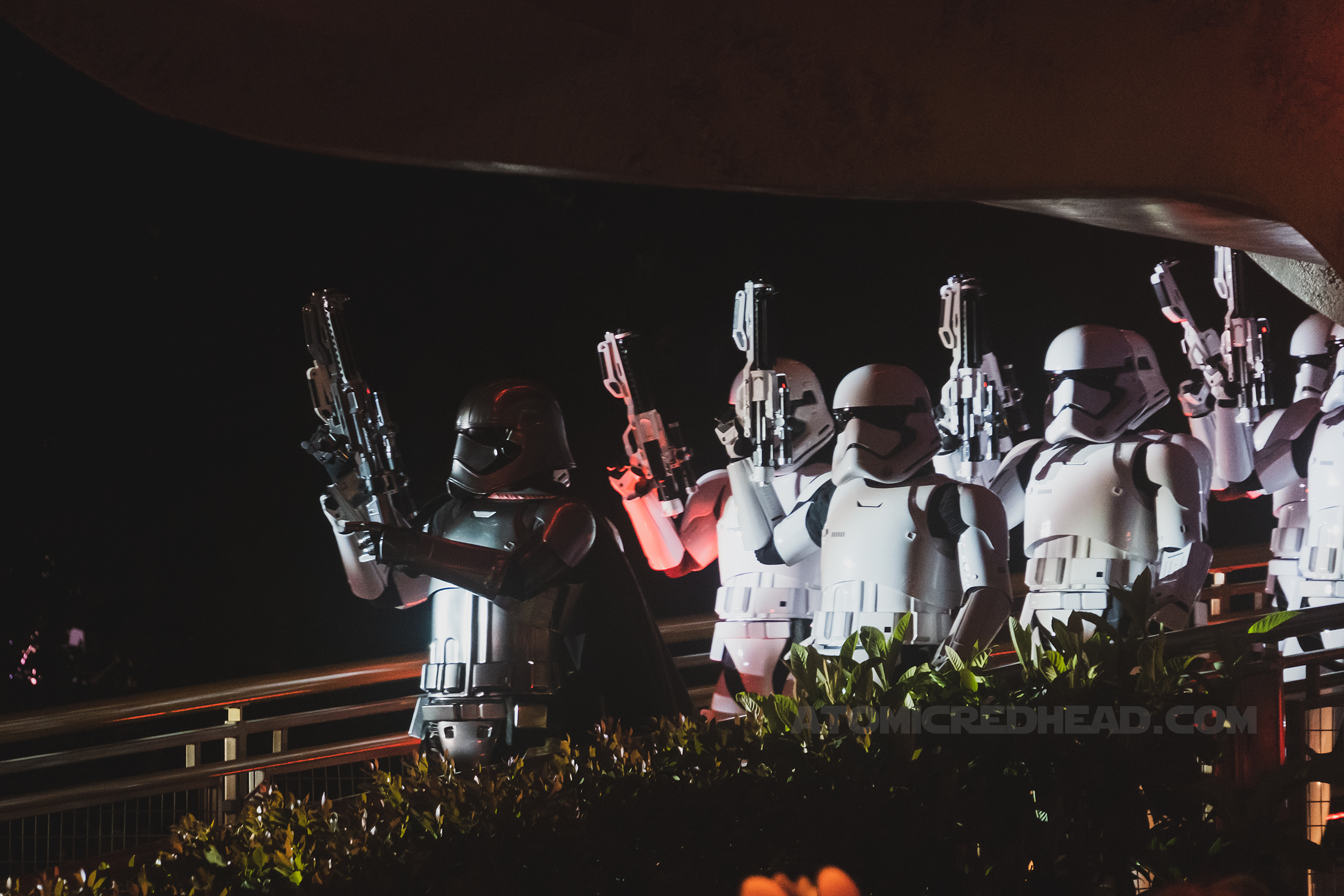 White stormtroopers and the silver clad Captain Phasma march through Tomorrowland.