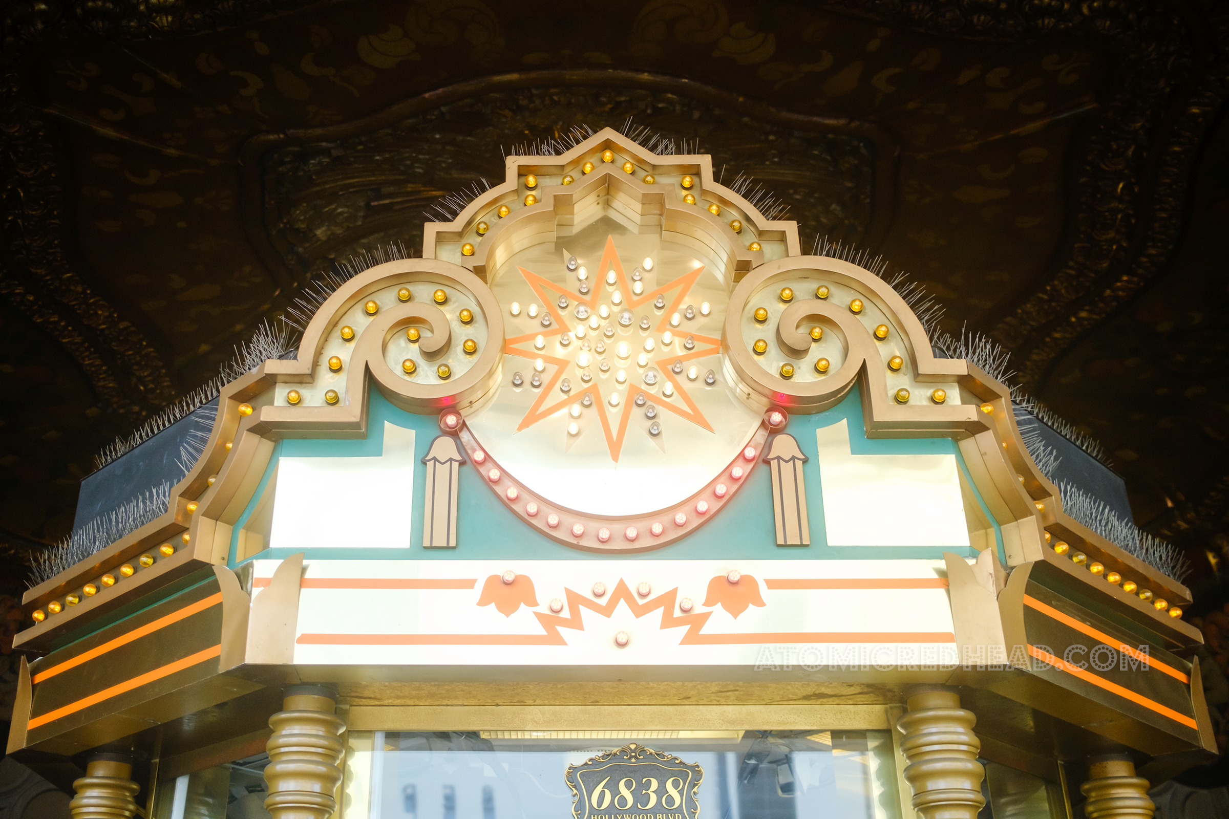Top of the box office, which features swirling gold patterns and bulbs.