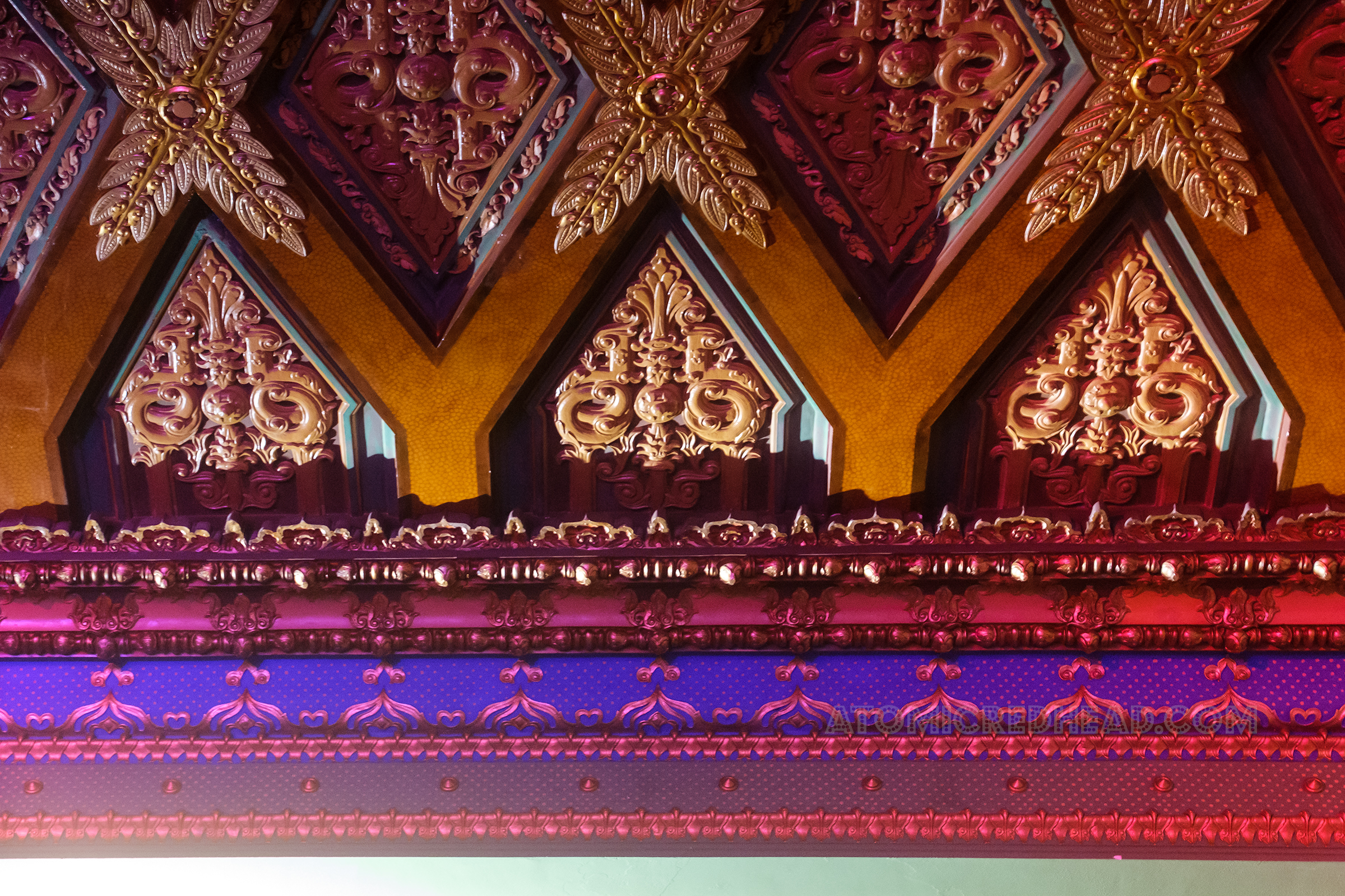 Intricate ceiling pattern of diamonds and curly qs.