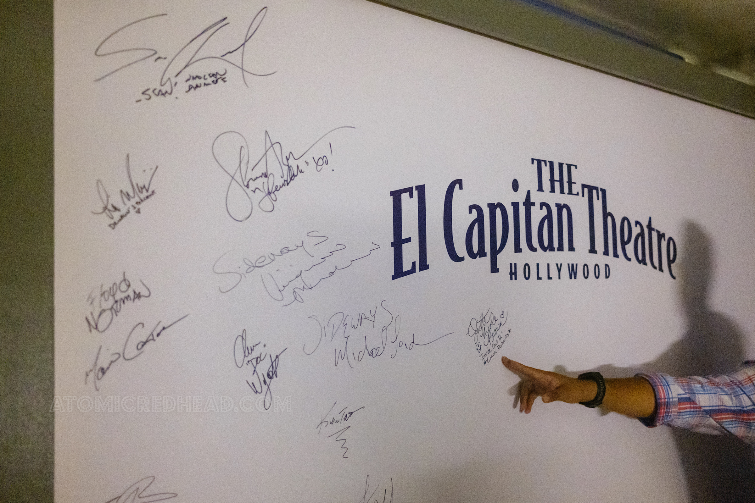 Backstage a large white panel reads "The El Capitan Theatre Hollywood" and features the signatures of many of the celebrities who have come to the theatre for events.