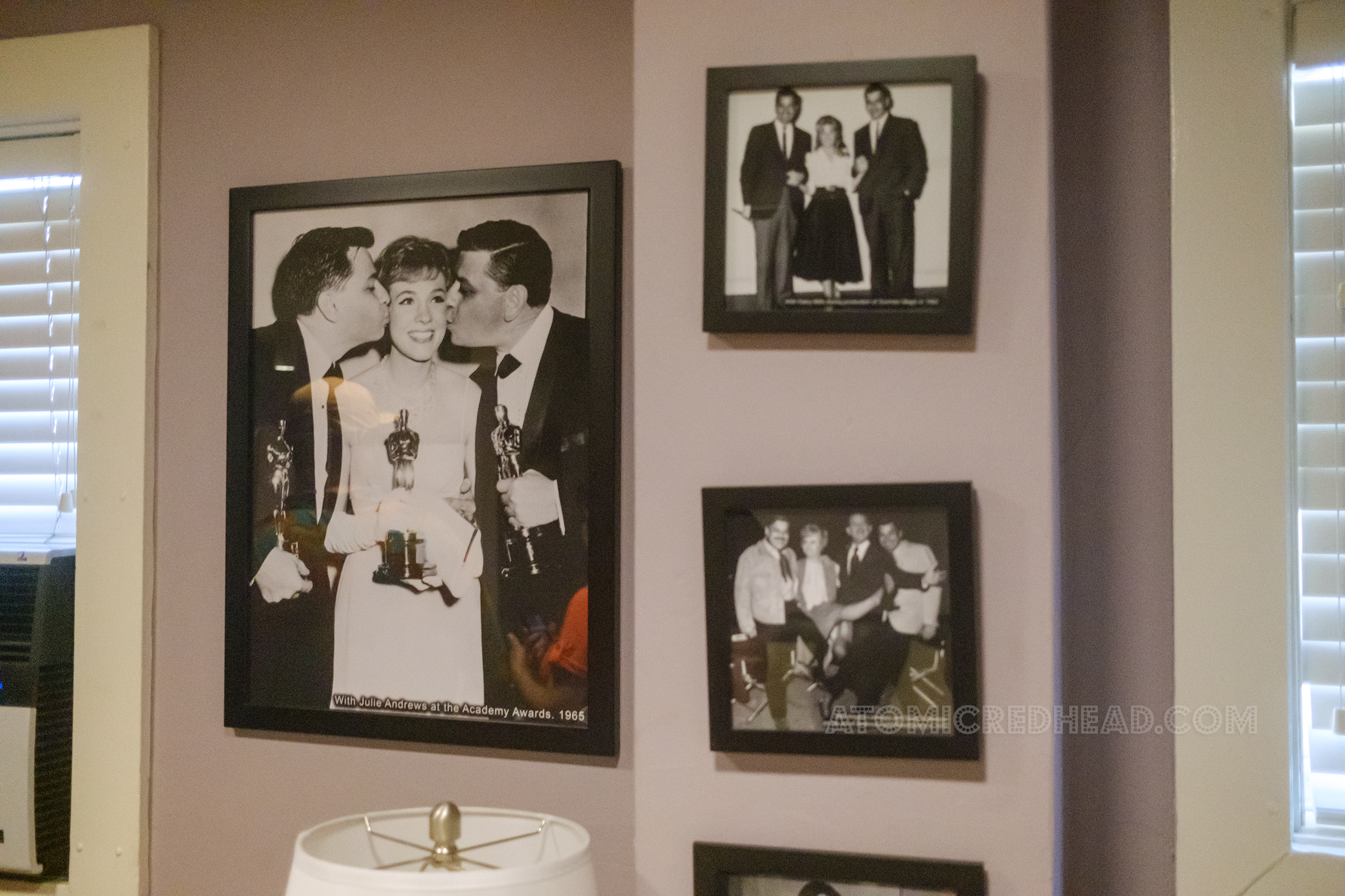 Framed black and white photos of the bothers with various stars from the films they worked on.