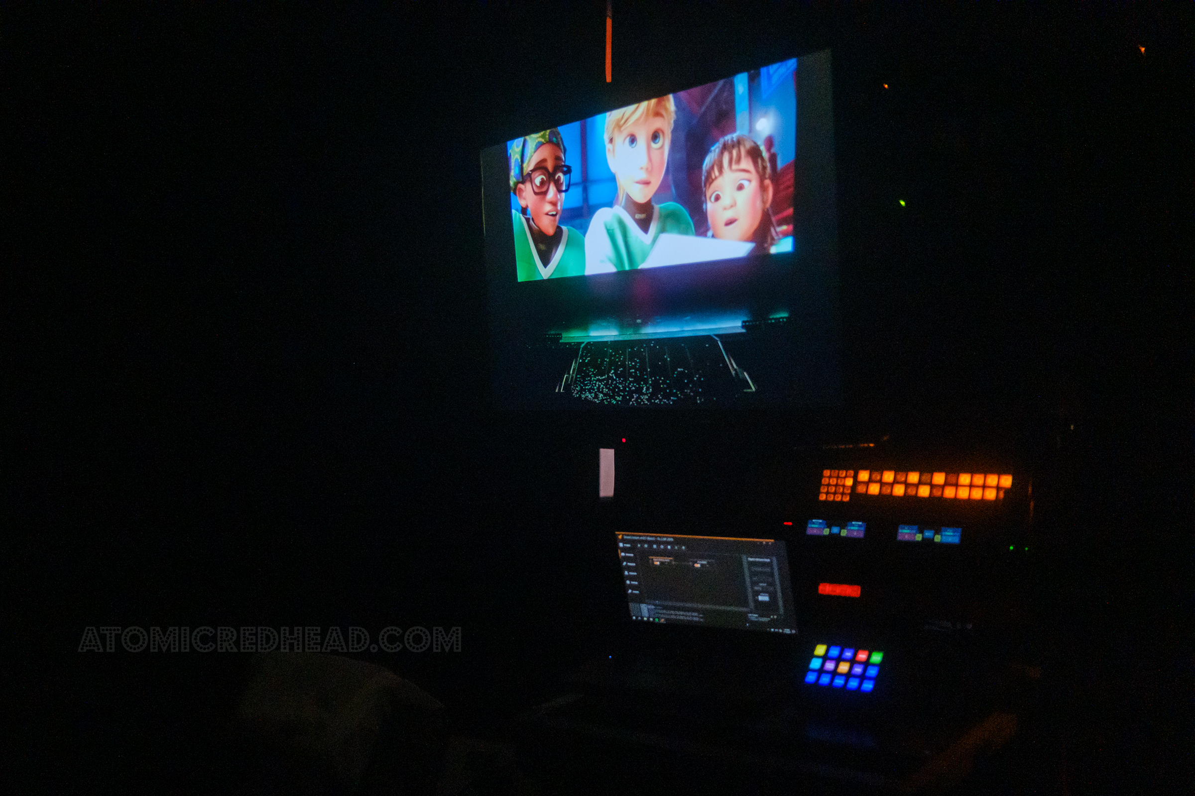 A view of the Stage Manager area, with screens and buttons along with a monitor to show what is currently on the movie screen, here an image of Riley from the film Inside Out is on the screen.