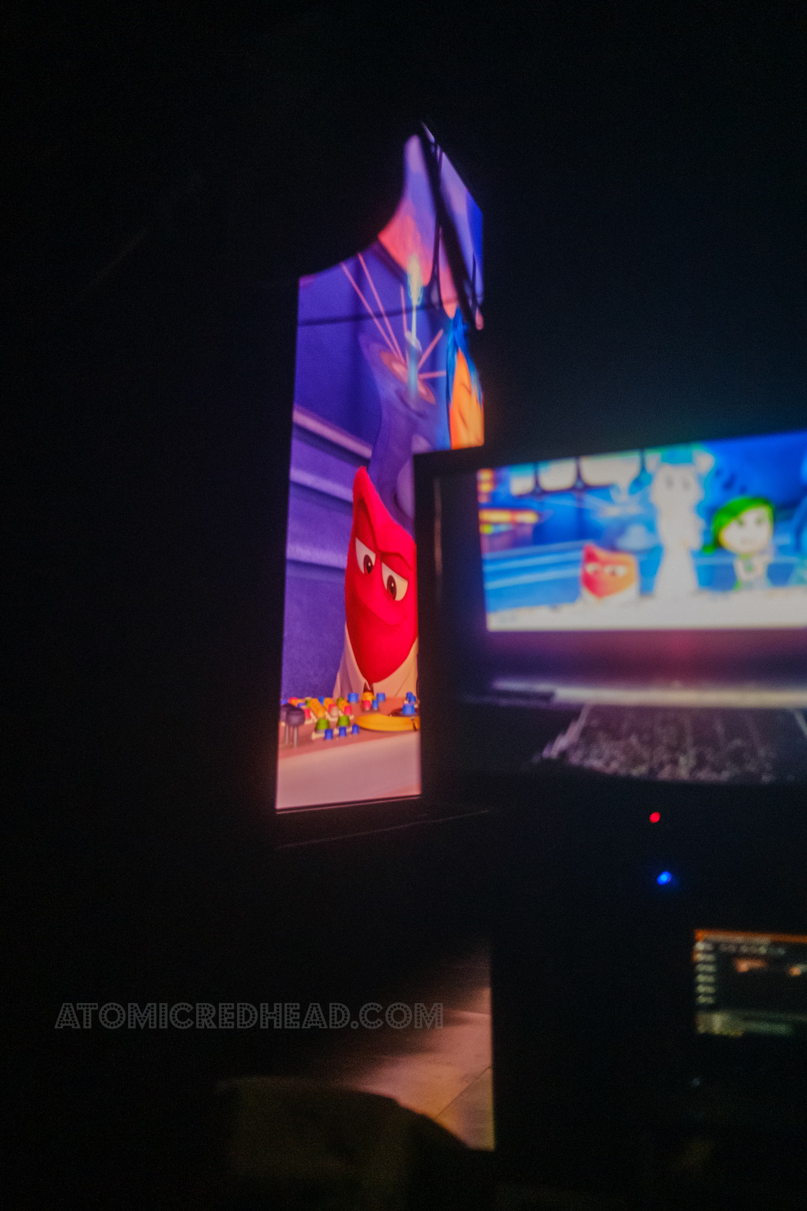 View of the massive movie screen from backstage, the same image on the screen, this time of the various emotions inside Riley's head, are seen on both the massive screen and the monitor backstage.
