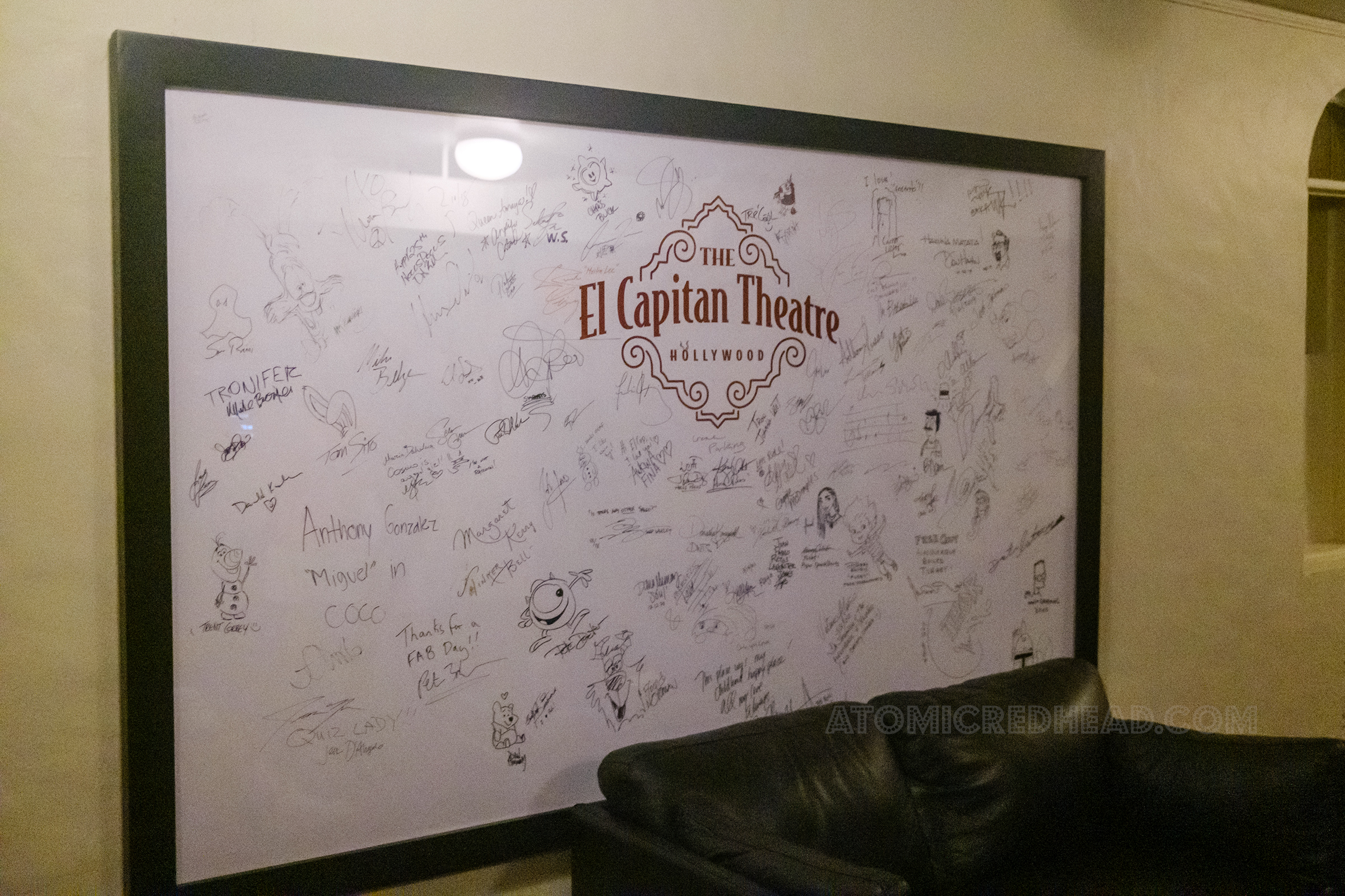 A similar panel to the one seen before, hangs in the Green Room, in large printed text it reads "The El Capitan Theatre Hollywood" and is filled with celebrity autographs and drawings.