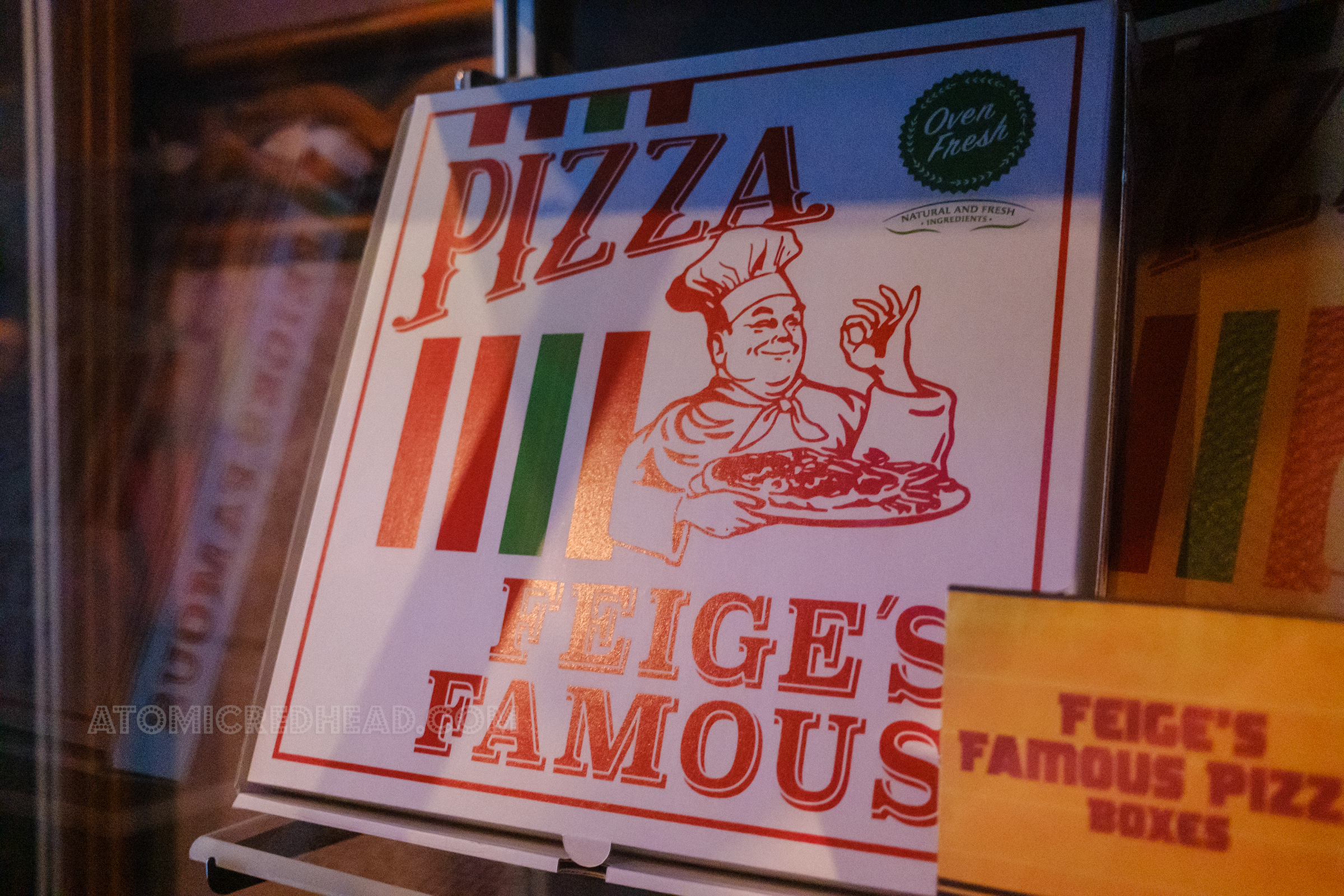 A prop box featuring a chef and text reading "Pizza Fiege's Famous"
