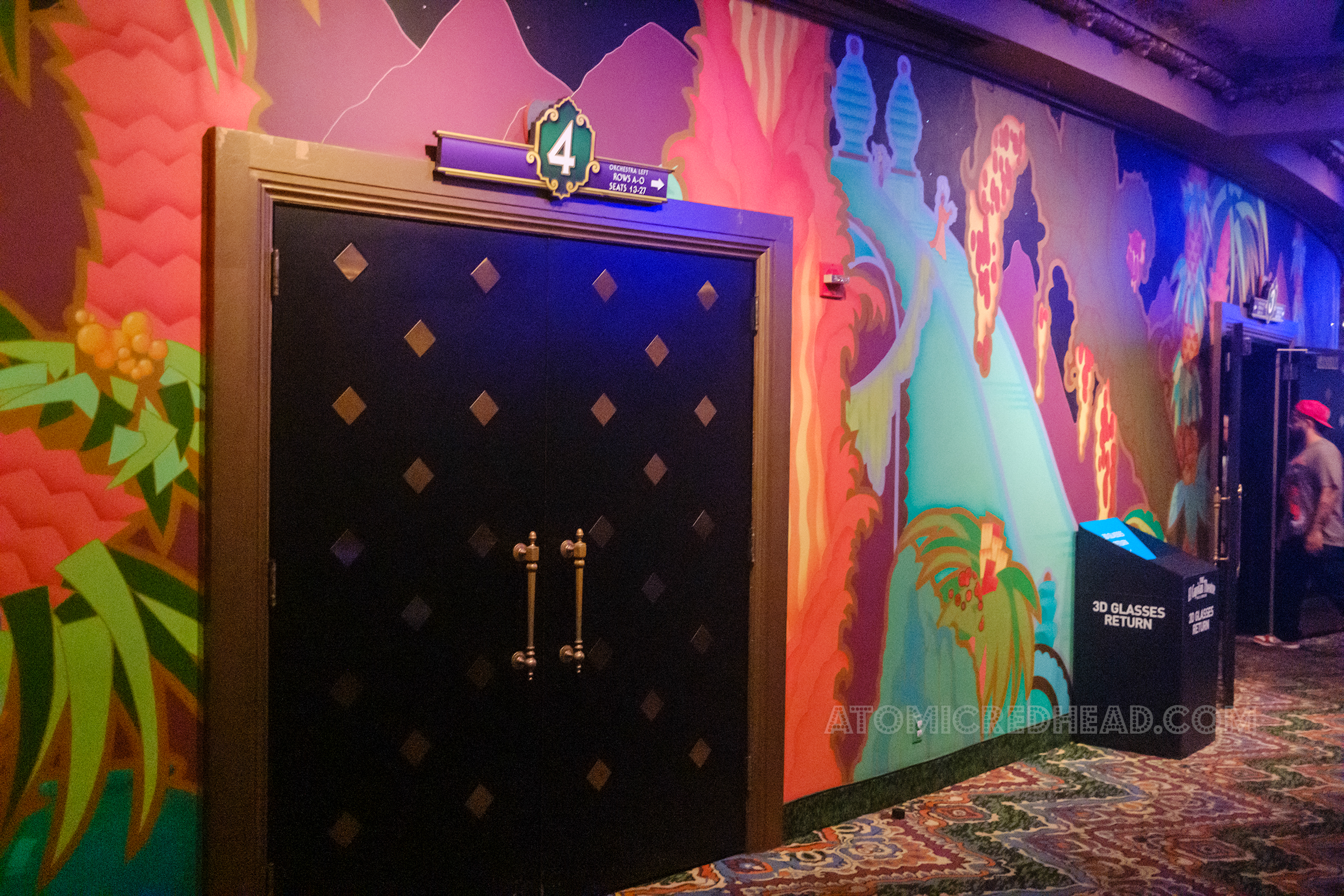 An Indian motif mural is painted on the wall that the doors to the lobby are on.
