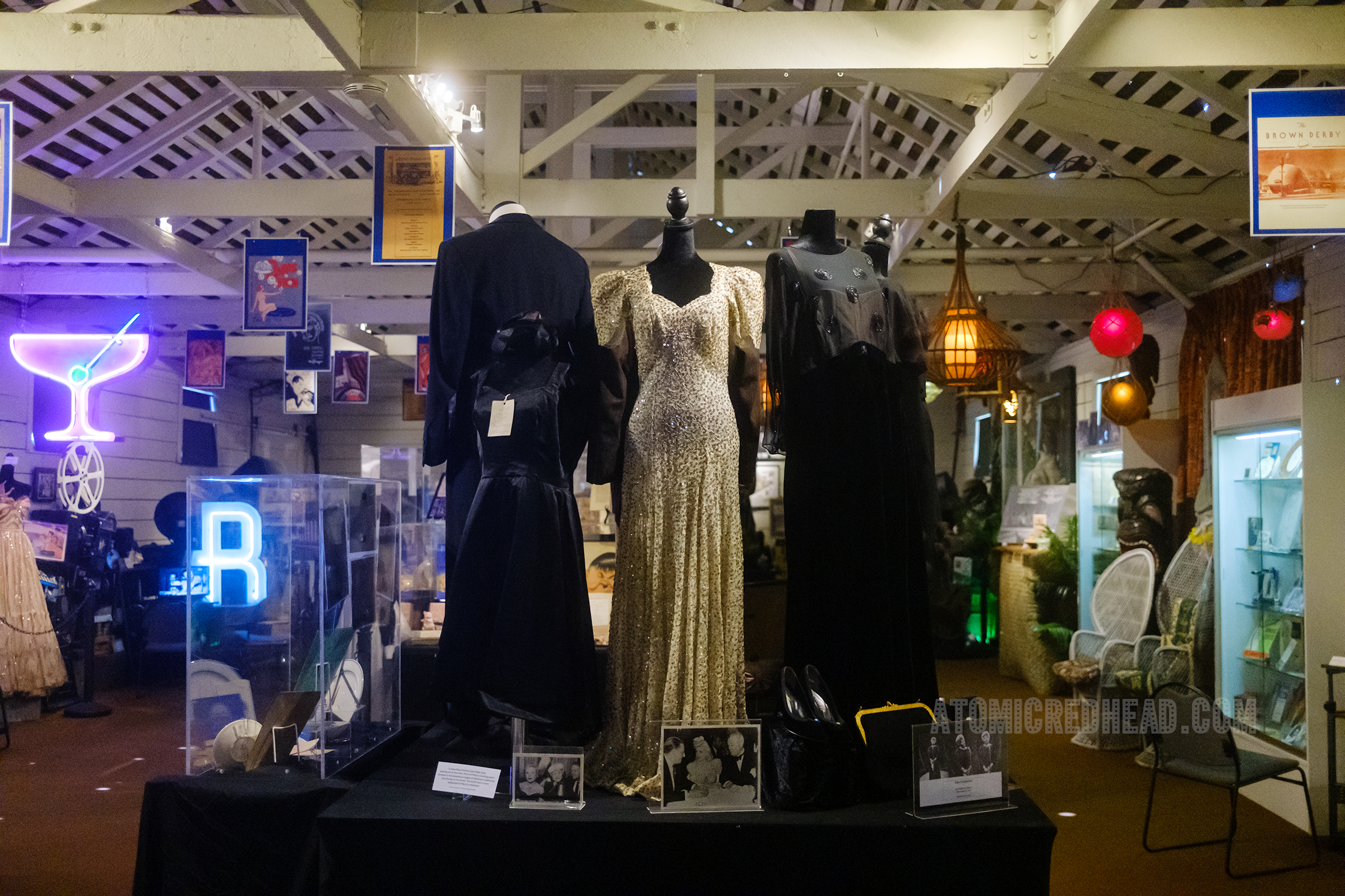 Overall view of one room, high on a table features mannequins dressed in glamours evening gowns.