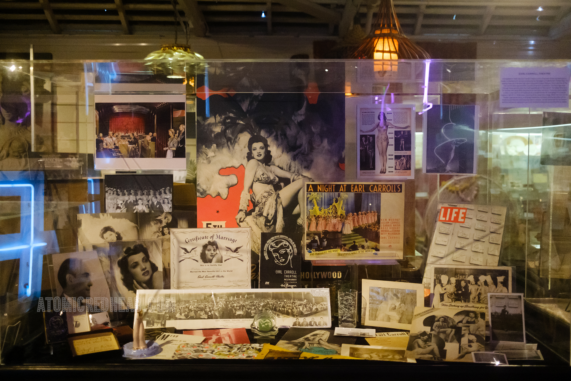 Display case housing a collection of items from the Earl Carroll, a nite club.