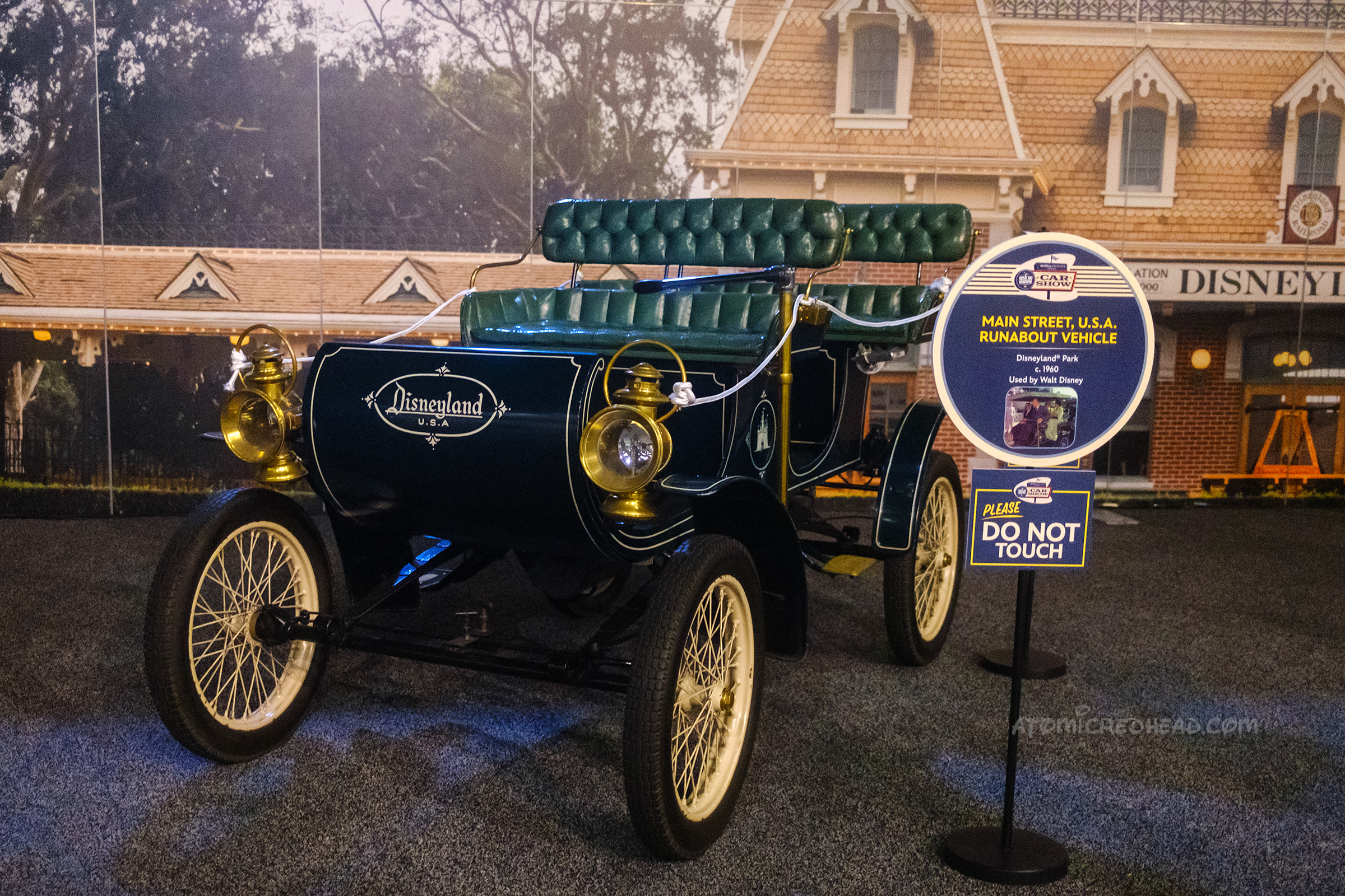 One of Main Street's "Horseless Carriages" made in 1960 to look like an early car, it is painted black, with pale yellow wire wheels, a dark green interior and "Disneyland" painted across the front.
