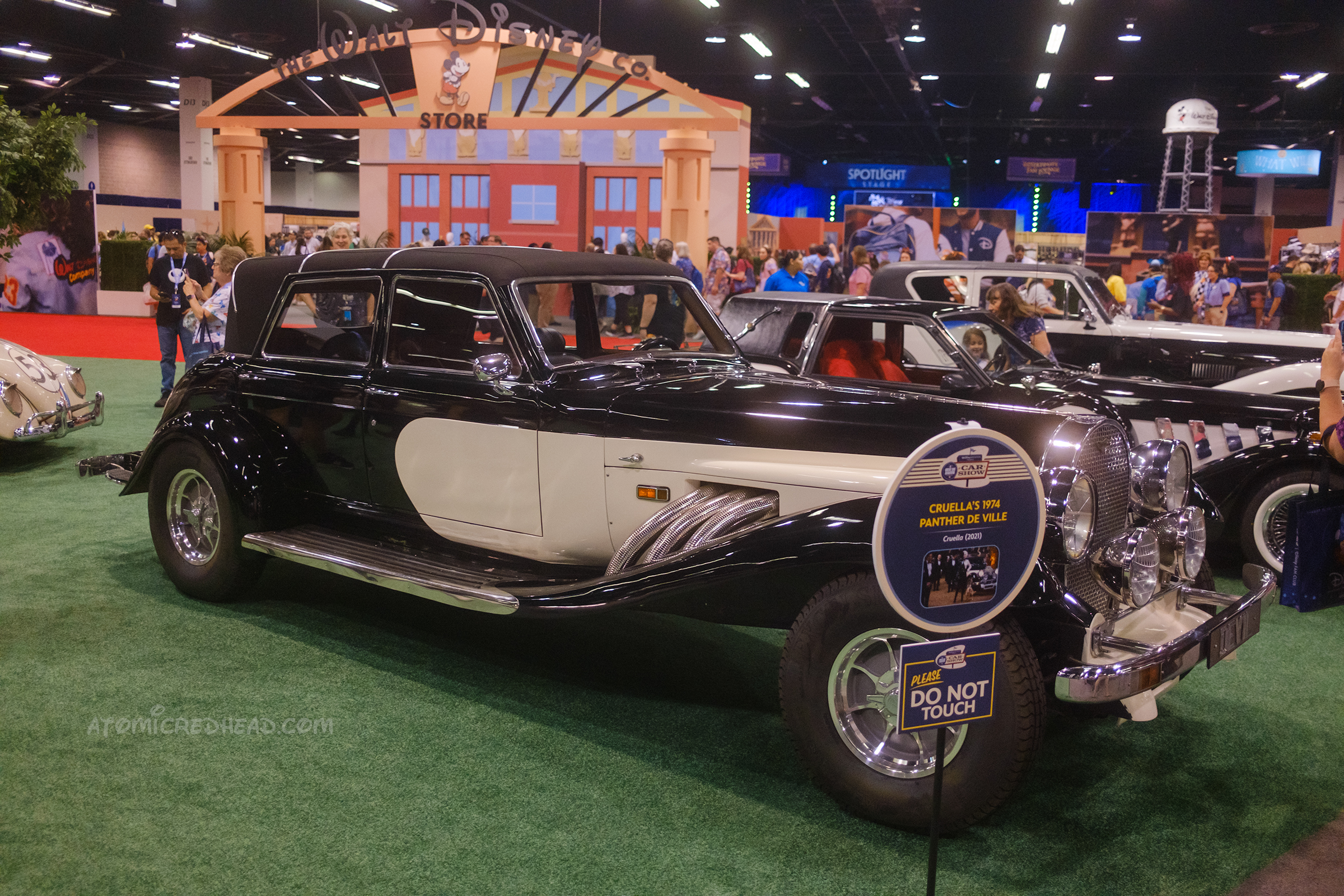 Overall image of the black and white 1974 Panther De Ville, a long swooping elegant car.