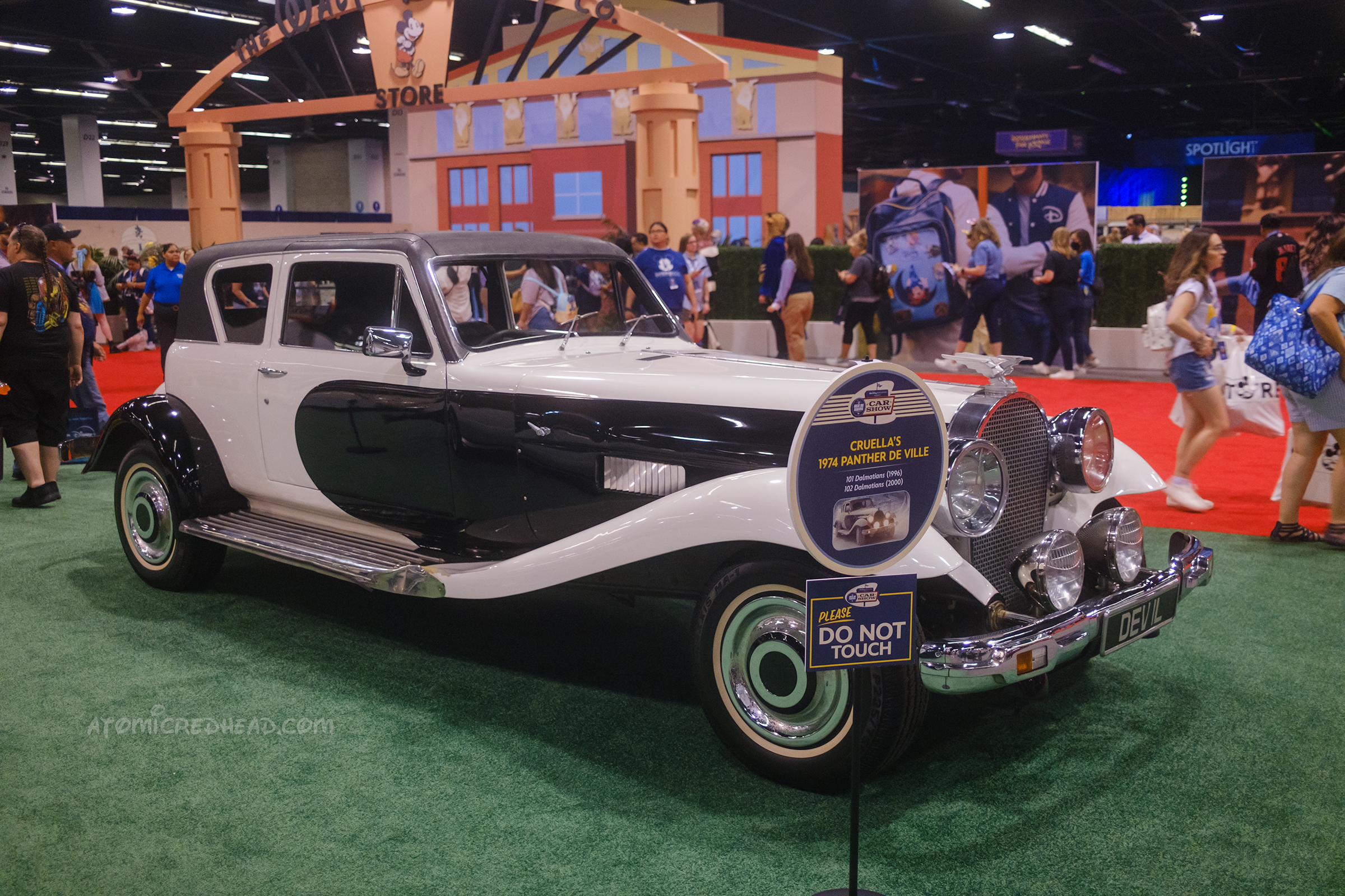 A black and white 1974 Panther De Ville featuring a long front an swooping fenders.