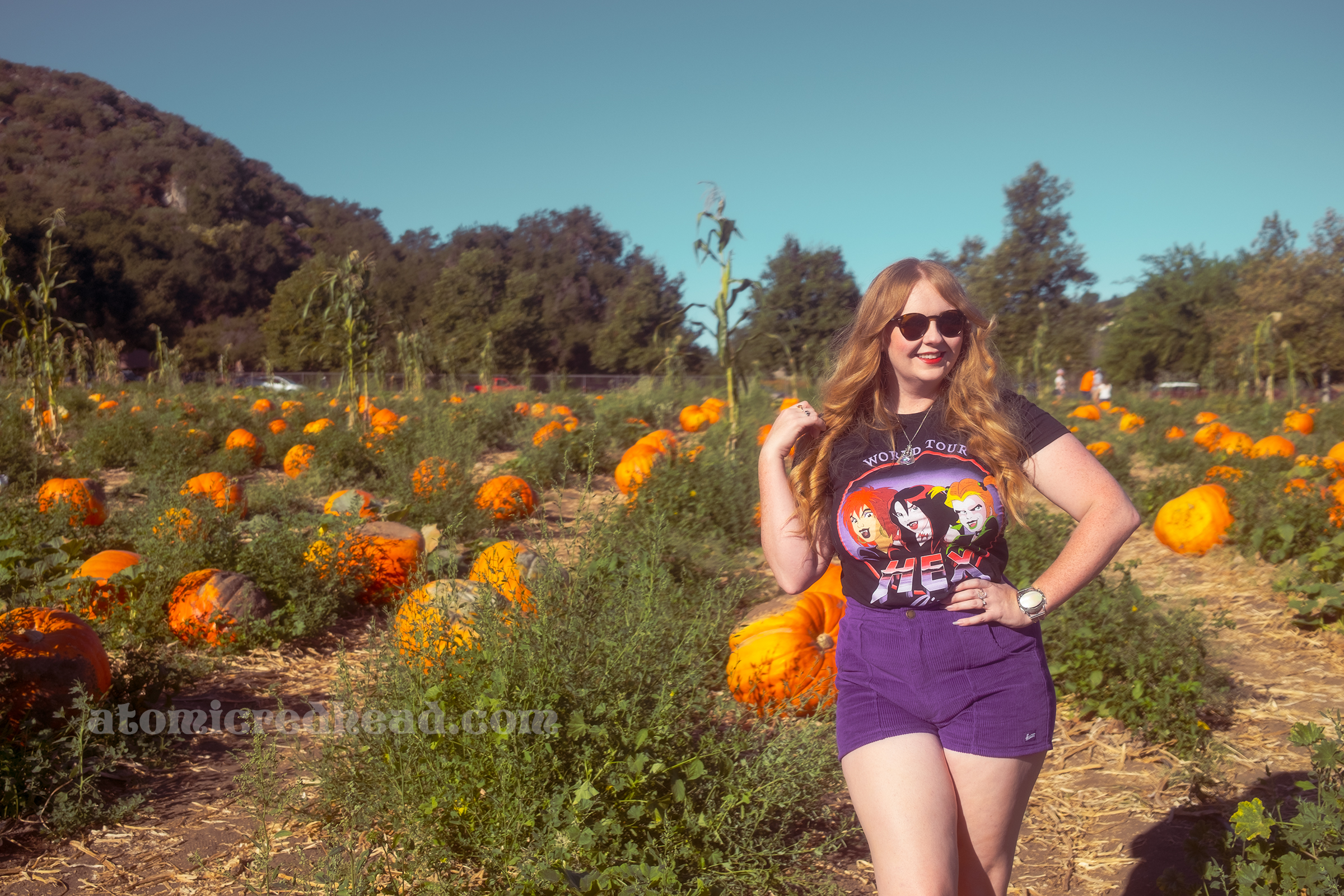 Myself, wearing a Hex Girls t-shirt and purple shorts, walking through the pumpkin Patch.