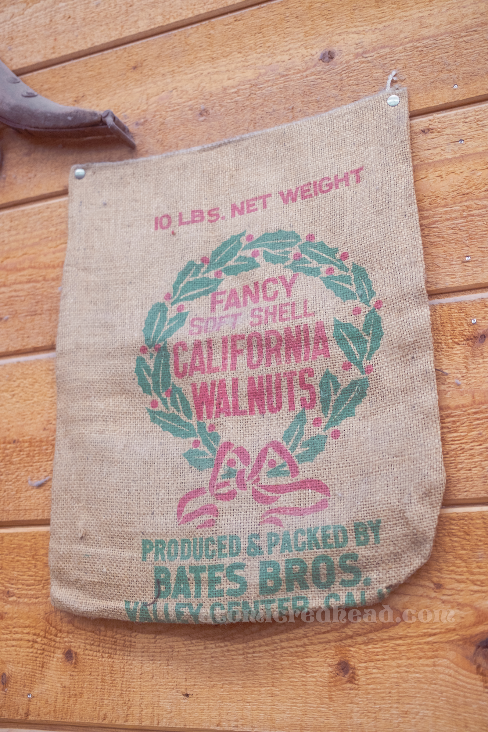 A vintage burlap back that reads "Fancy Soft Shell California Walnuts Produced and Packed by Bates Bros."