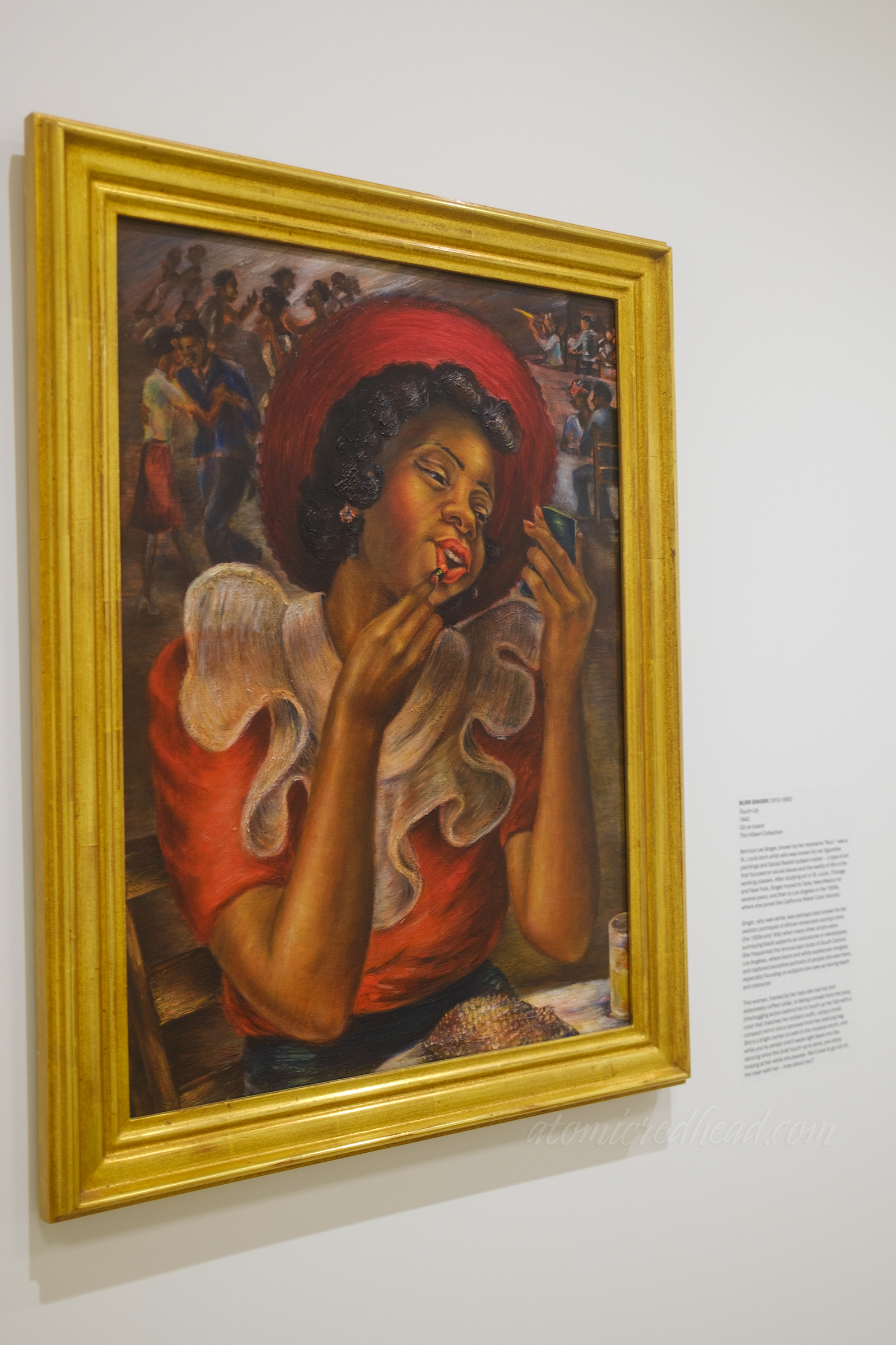 An oil painting of a Black woman in a red outfit touches up her lipstick.