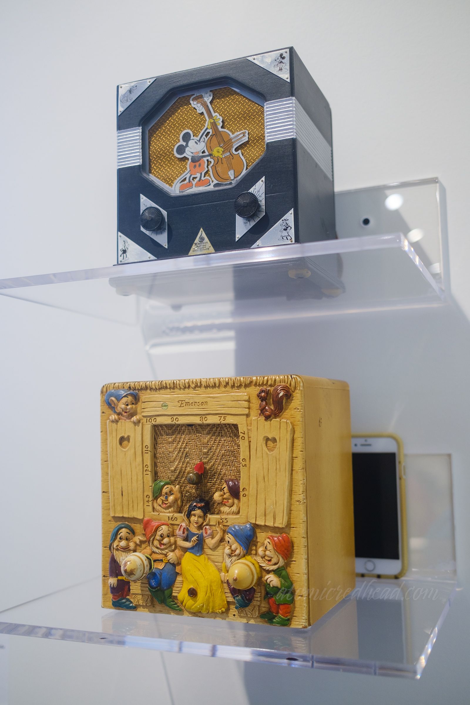 Two radios, the one on top features Mickey Mouse, the one below Snow White and the Seven Dwarves.