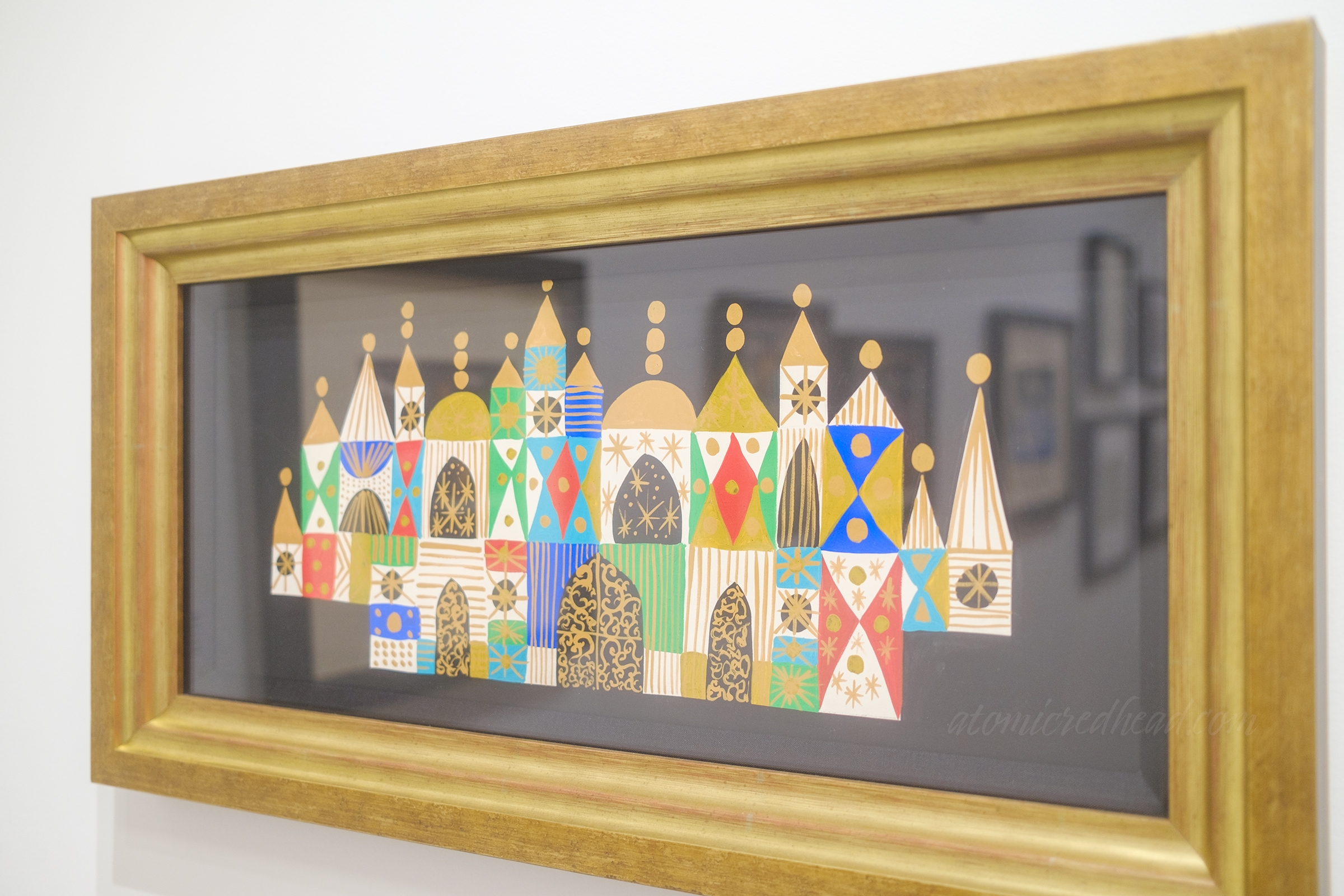 Concept art for the front of "it's a small world" with colorful geometric designs.