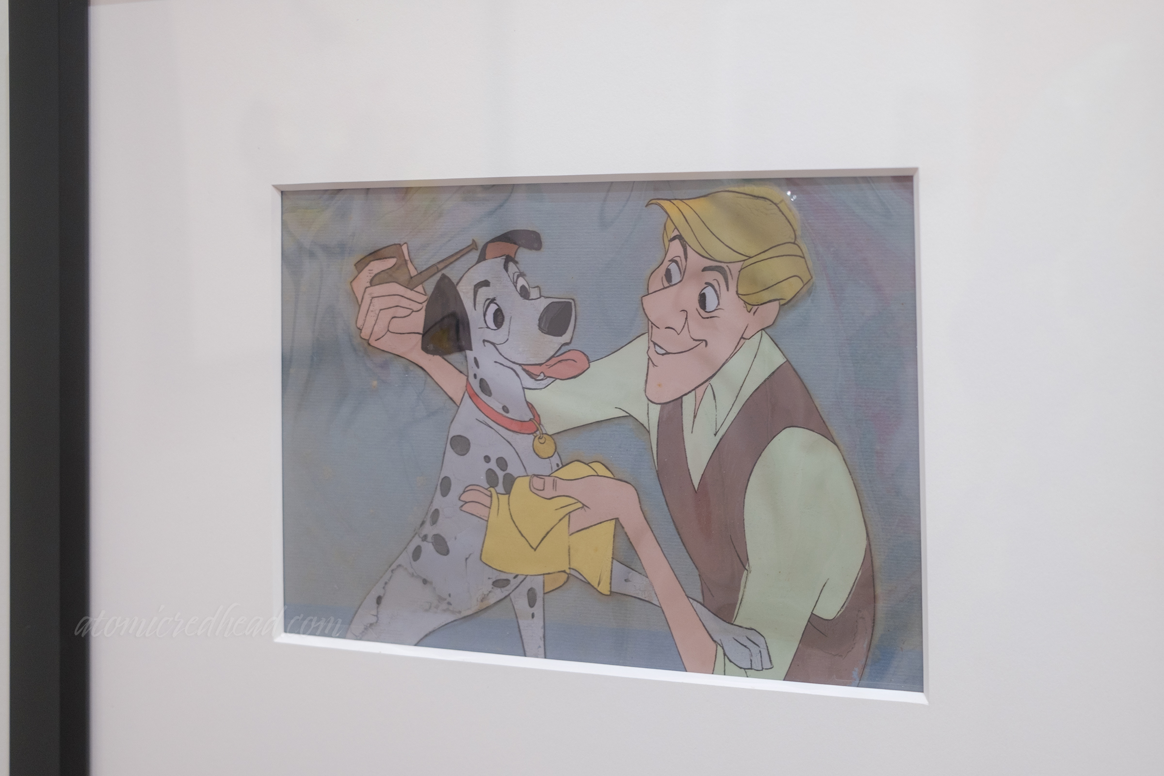 Animation cell from 101 Dalmatians, here Roger, the owner, cleans his dog's, Pongo, face.