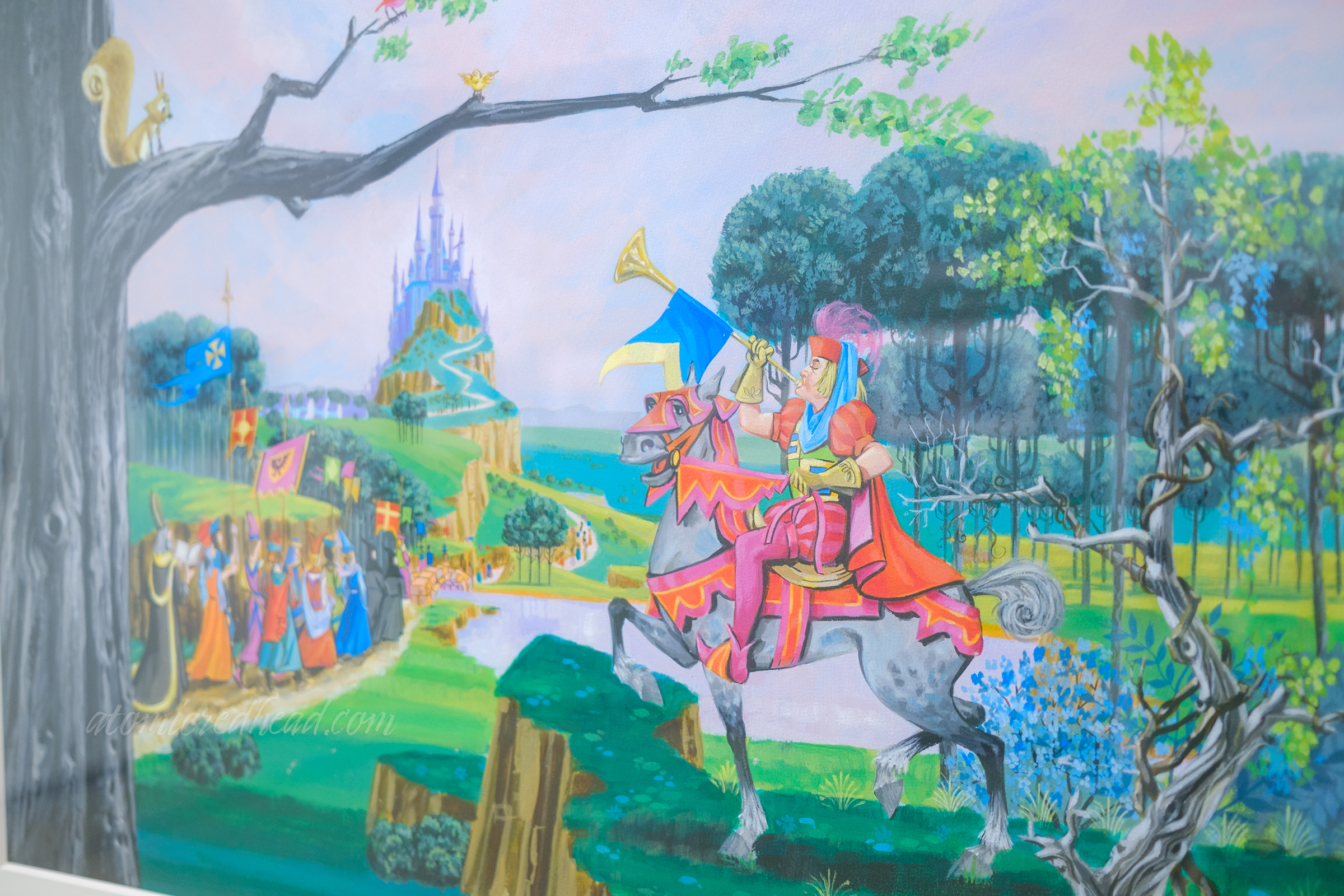 A man on a horse blows a trumpet, welcoming people to the castle, in artwork for the Sleeping Beauty attraction at Disneyland.