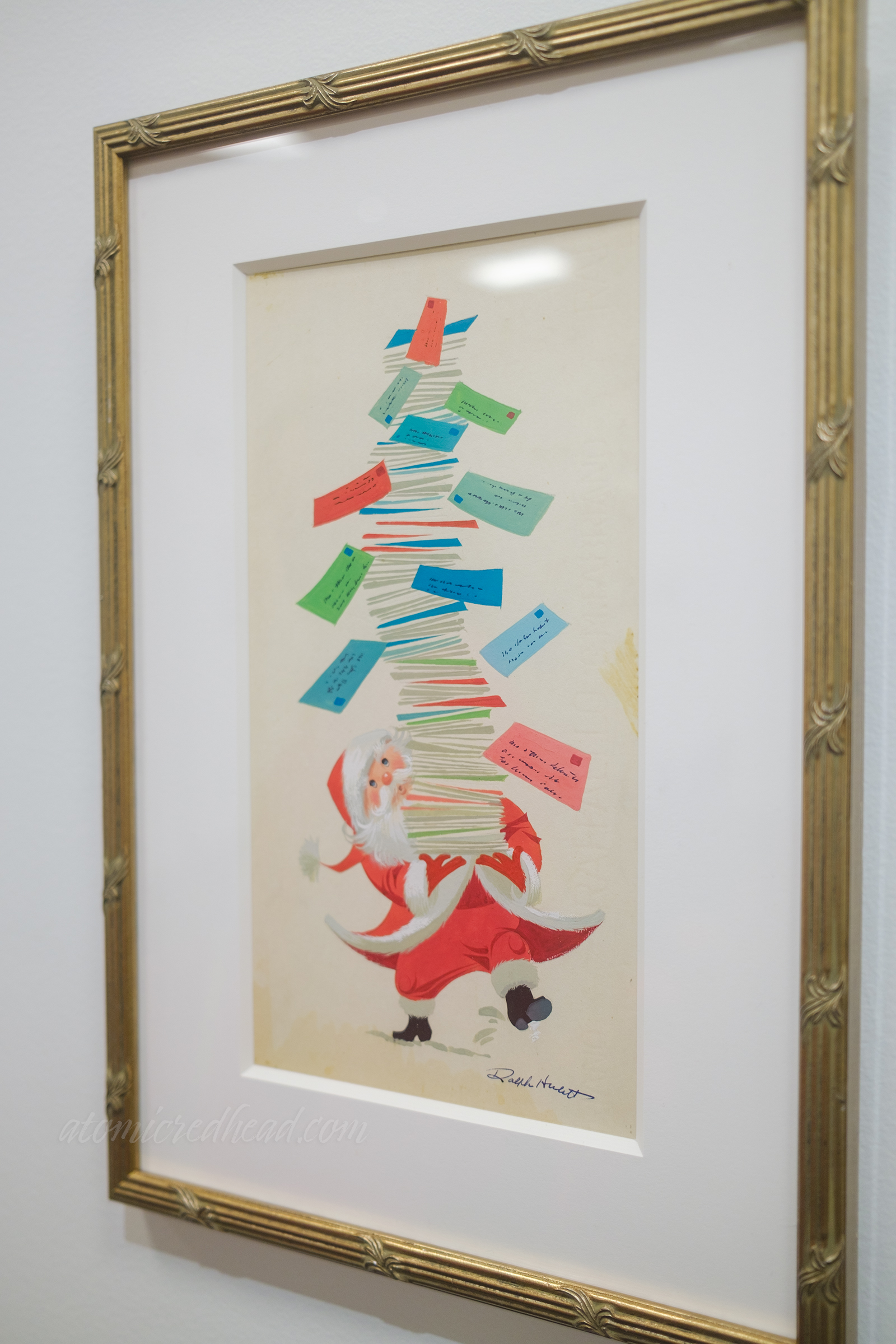 Santa carries a massive stack of letters, with some falling, giving the shape of a Christmas tree.