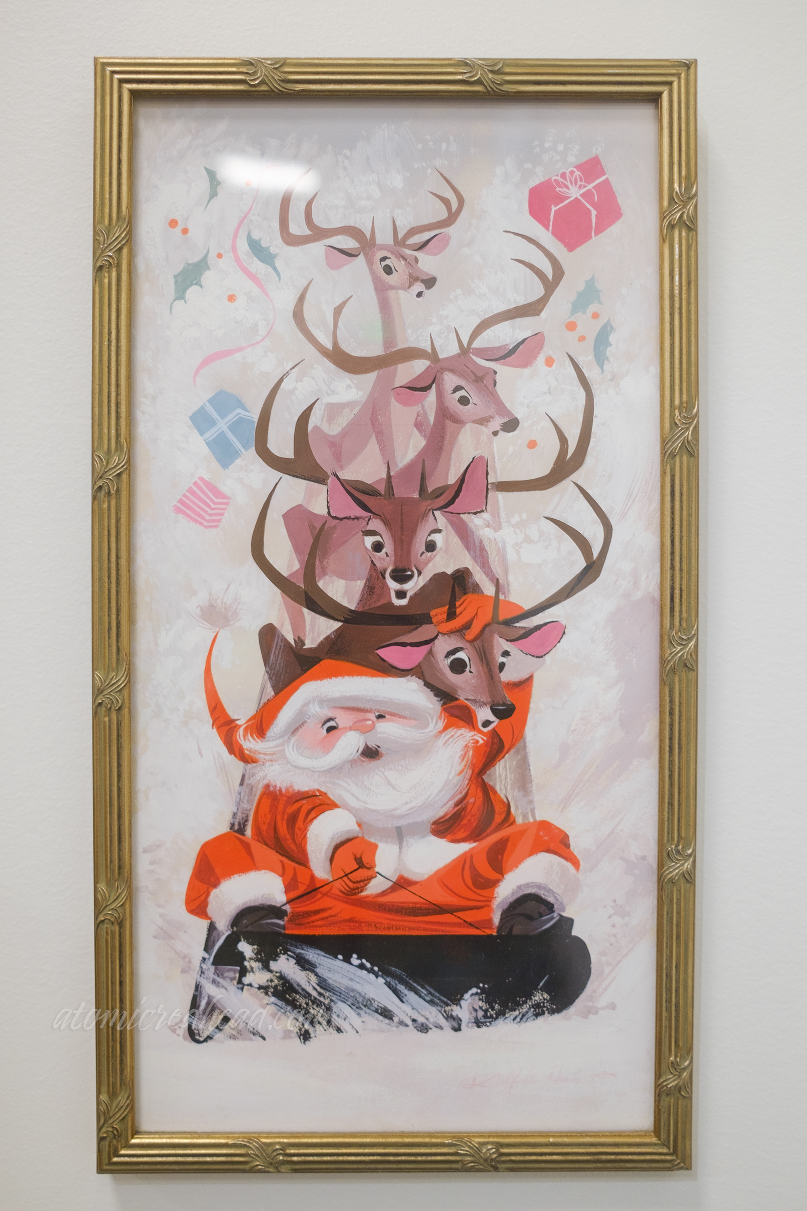 Santa rides the front of a sleigh, with his deer onboard behind looking afraid.