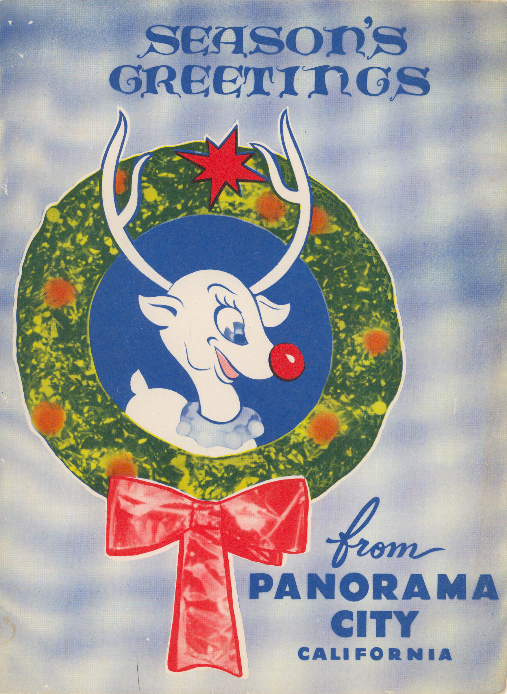 A cartoon reindeer sits within a wreath. Script reads "Season's Greetings from Panorama City California"