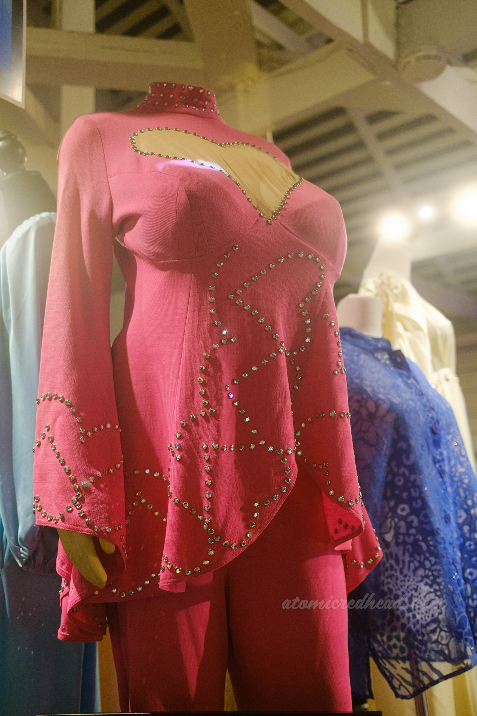 A pink tunic and pants set with rhinestones on it, and a cut out heart detail at the chest, worn by Bea Arthur.
