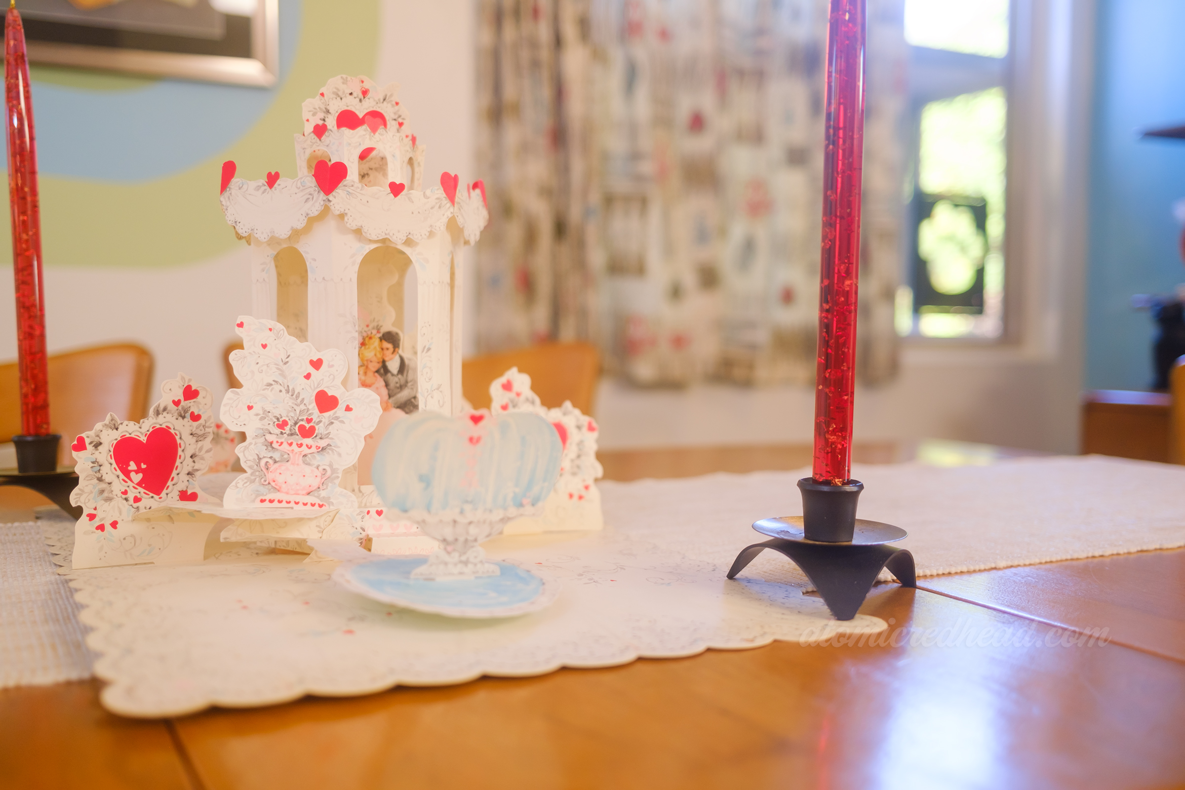 A pop-up decoration on our dining room table of a couple in a gazebo.