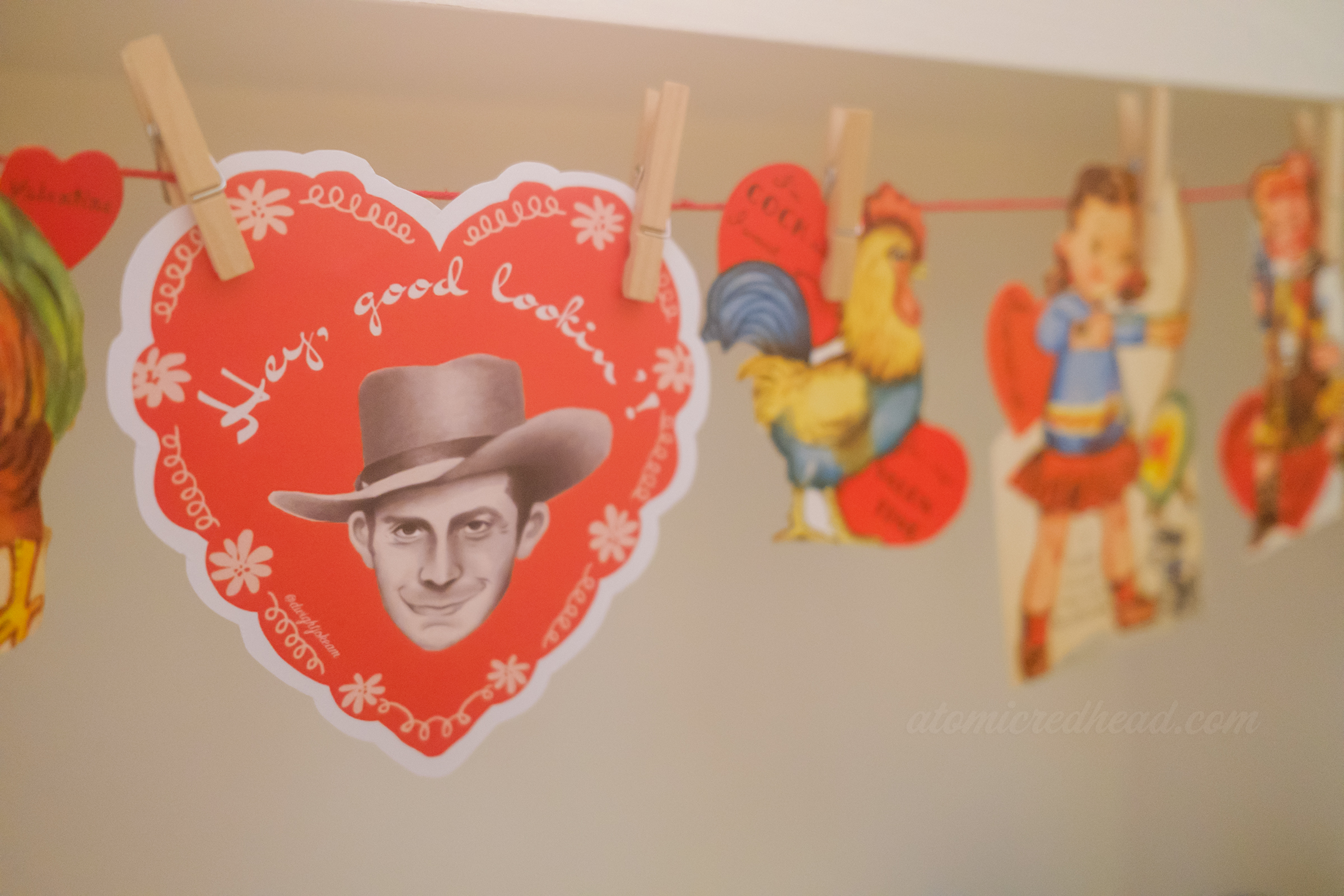 A heart shaped valentine features an illustration of Hank Williams and reads "Hey Good Lookin'!"