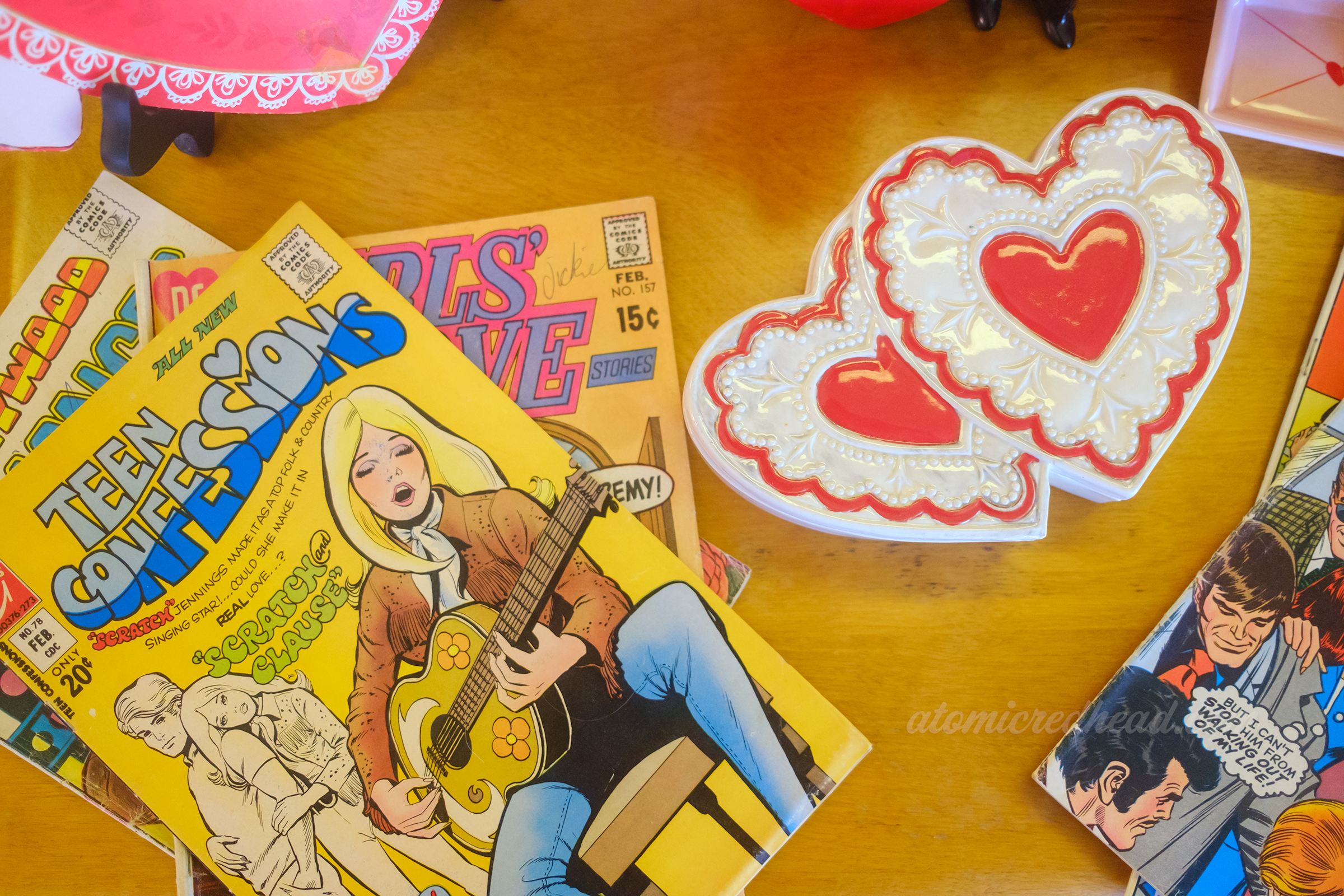 Vintage romance comics lay on a table.