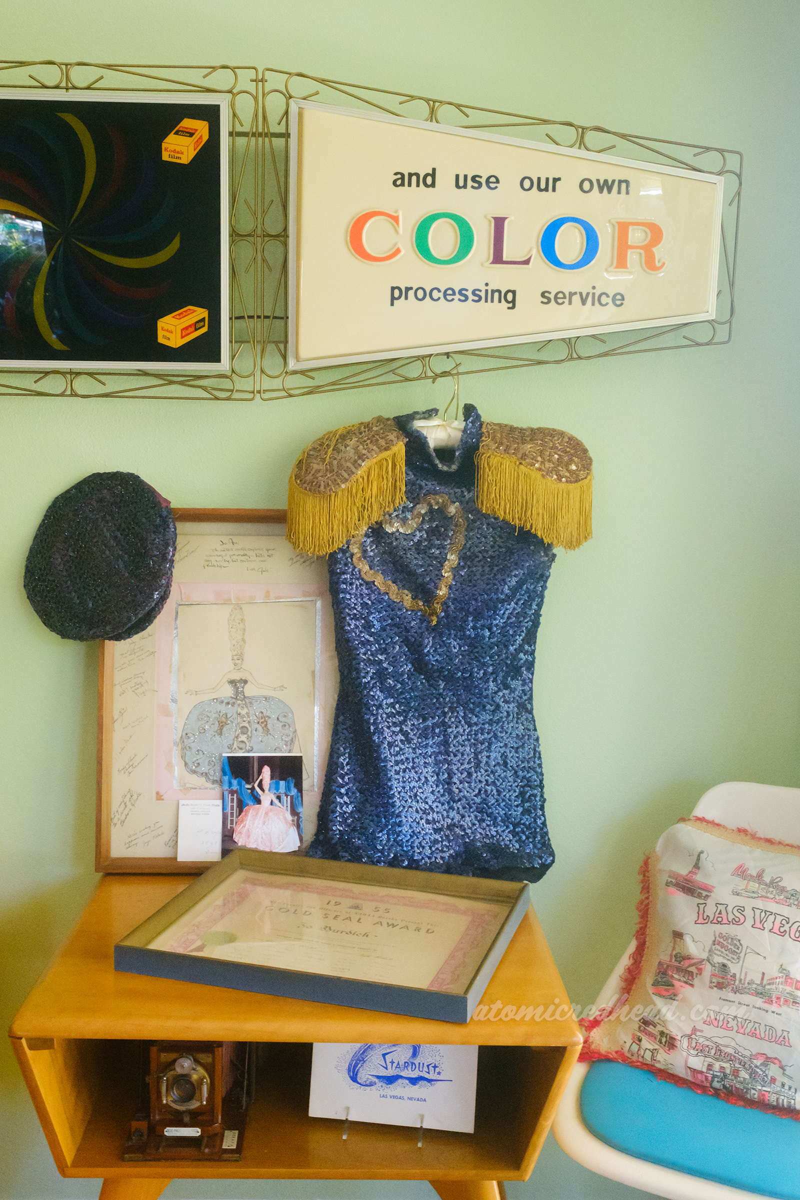 Illustration of Jo in costume, along with a photo, and a sequined costume of dark blue.